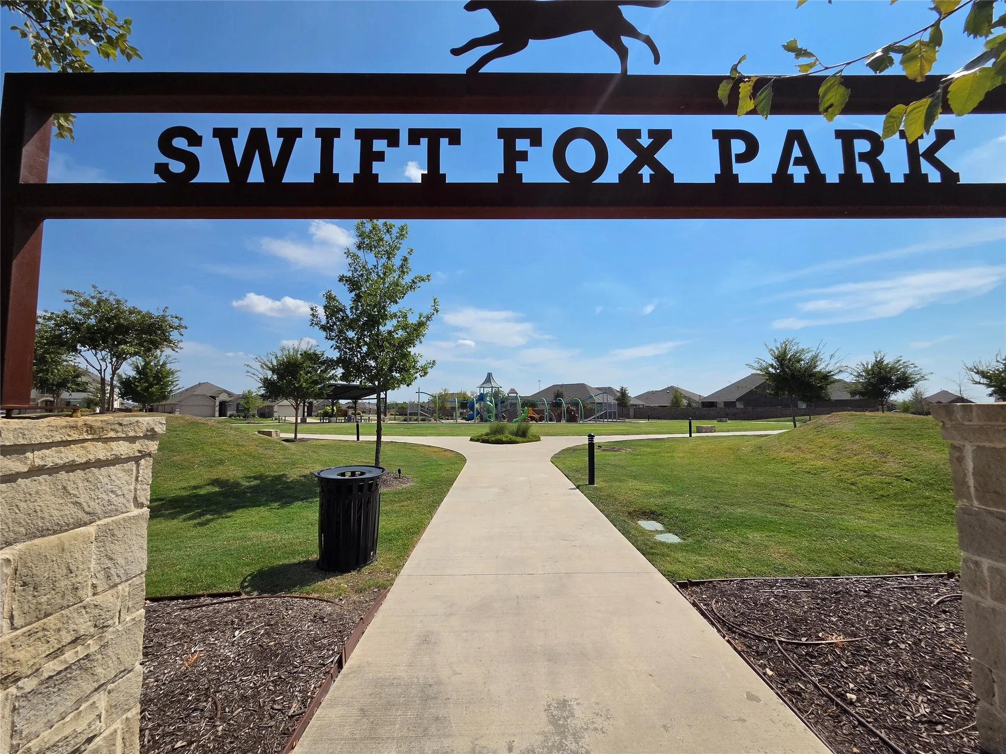 Swift Fox Park entry featuring stone pillars and a metal archway