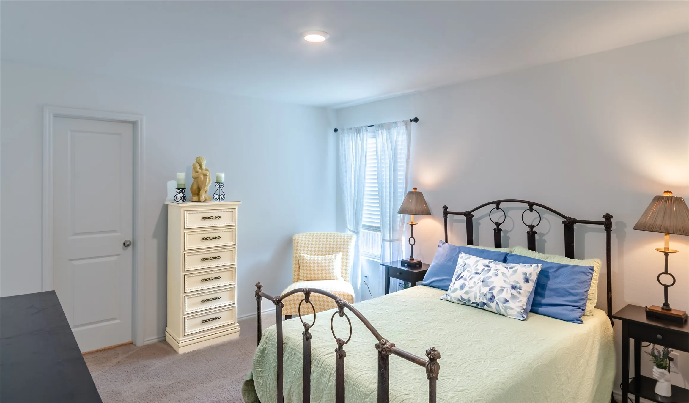 Recessed ceiling lighting, soft neutral wall paint, and carpet flooring