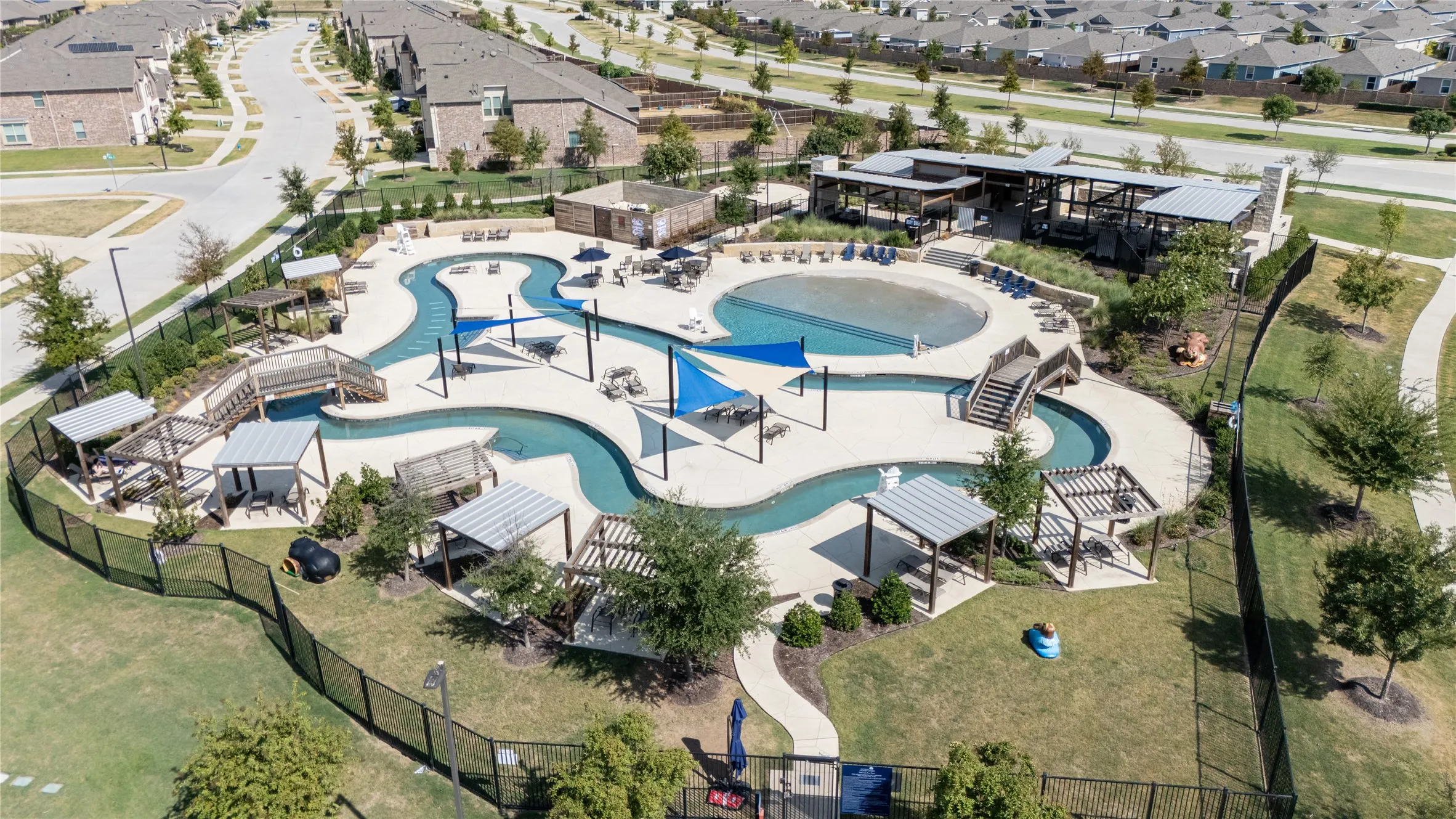 Community amenity center featuring a resort-style pool with a lazy river and a separate shallow-entry pool