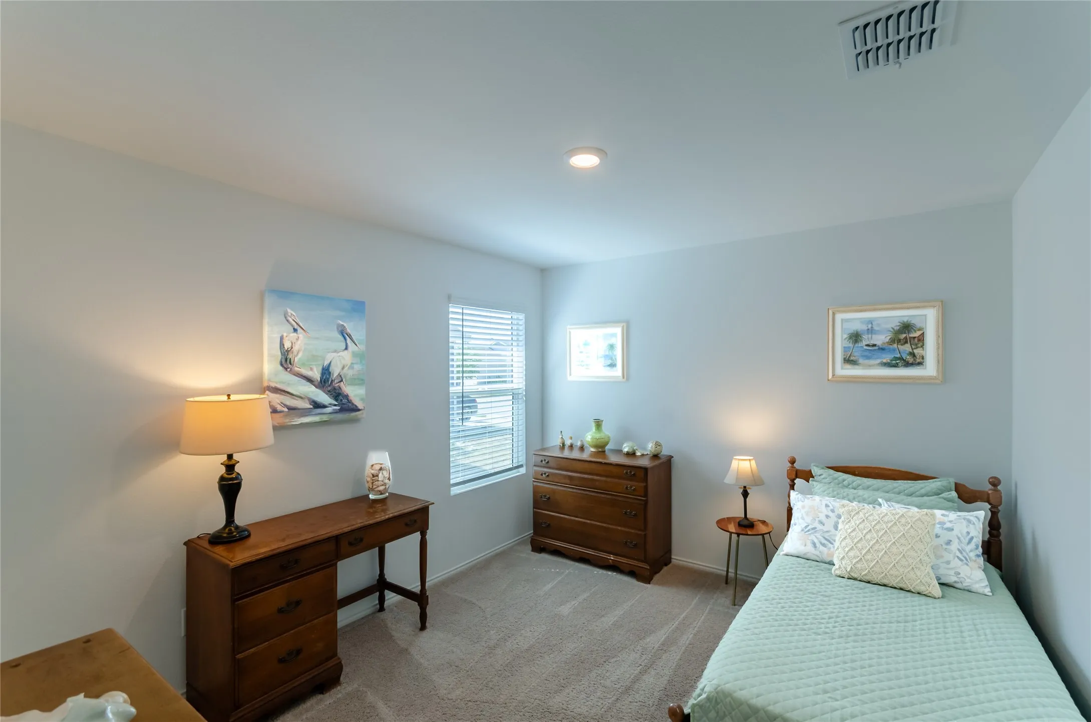 Recessed lighting, light-toned carpeting, and a window with horizontal blinds