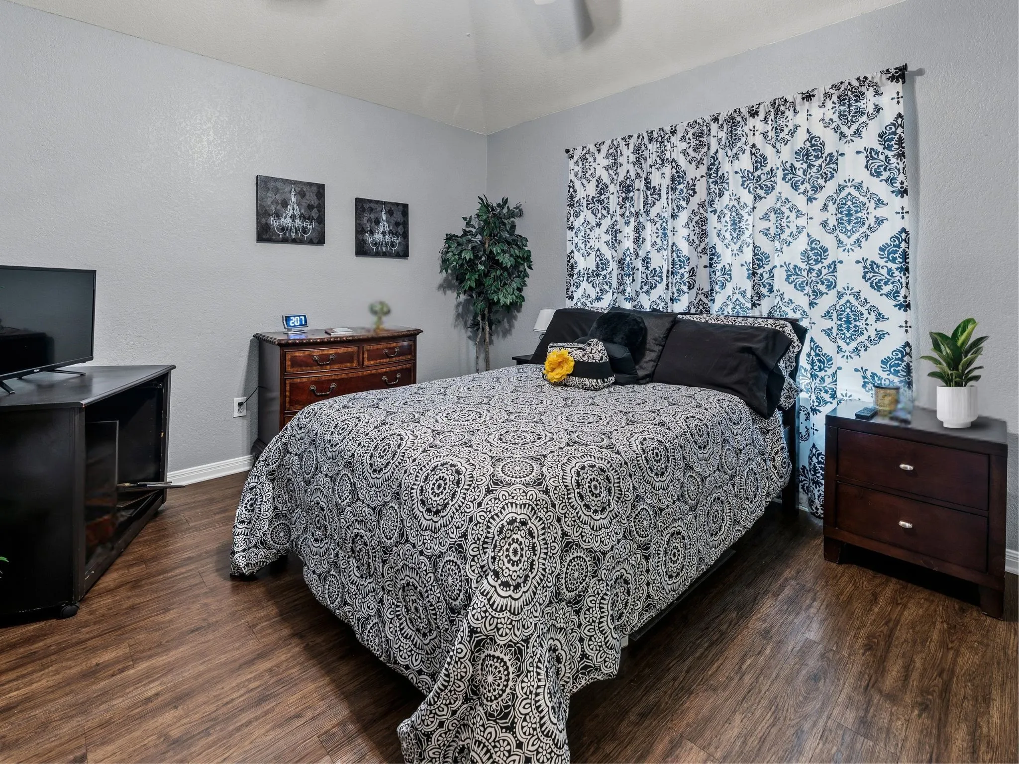 Wood-finish flooring, vaulted ceiling, and light gray wall paint