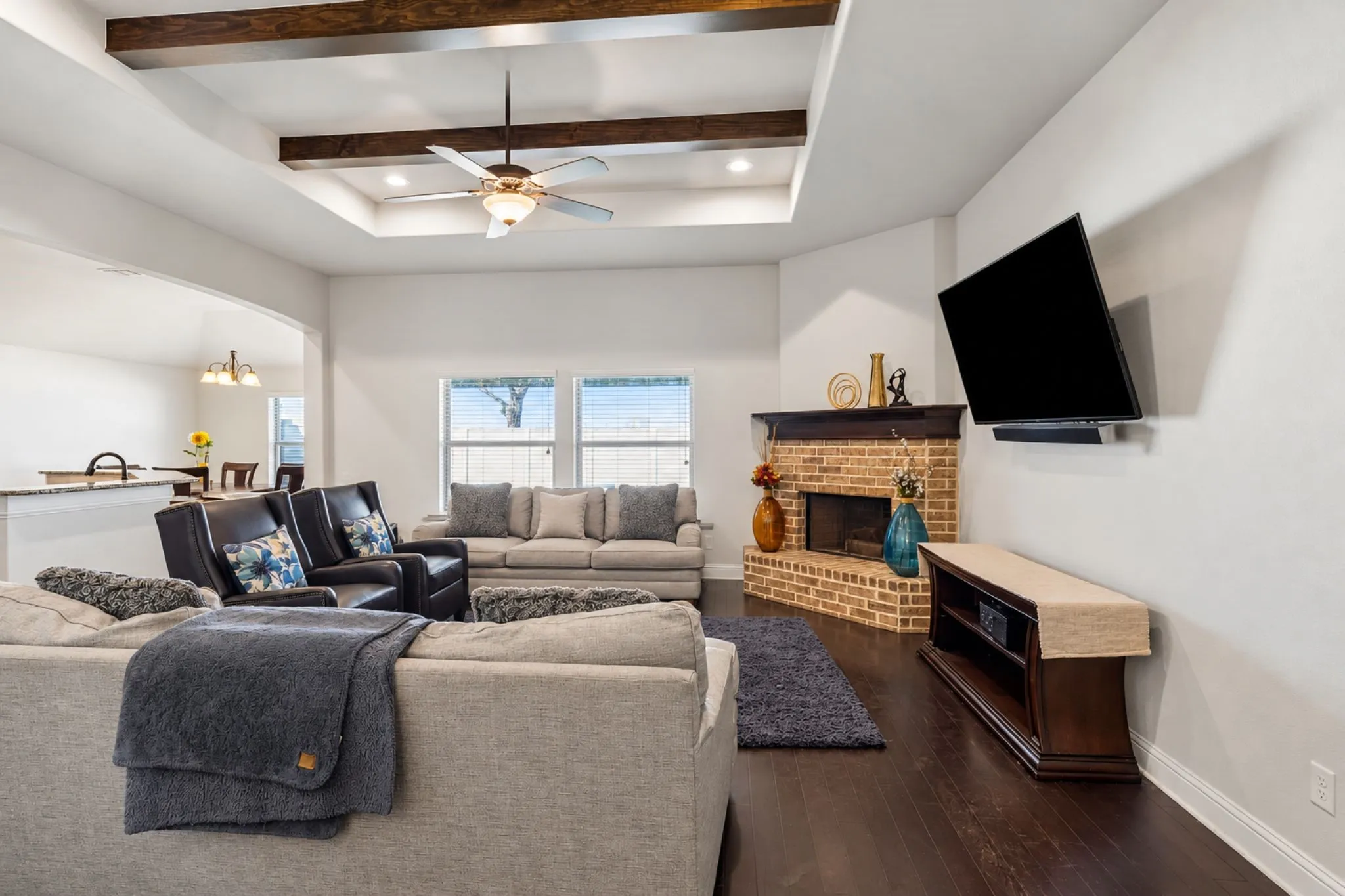 Tray ceiling with wood-finish beams and recessed lighting