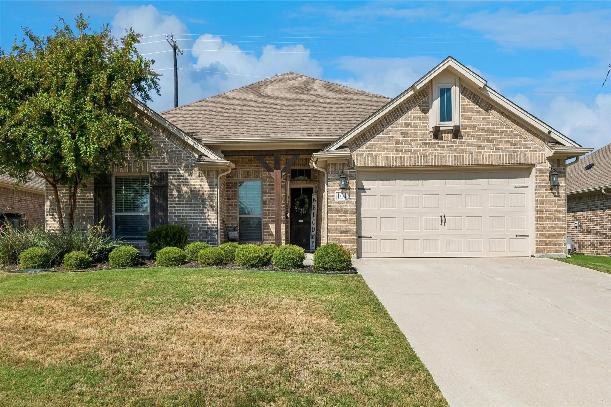 Brick exterior with a gabled roof and attached​​‌​​​​‌​​‌‌​‌‌​​​‌‌​‌​‌​‌​​​‌​​ garage