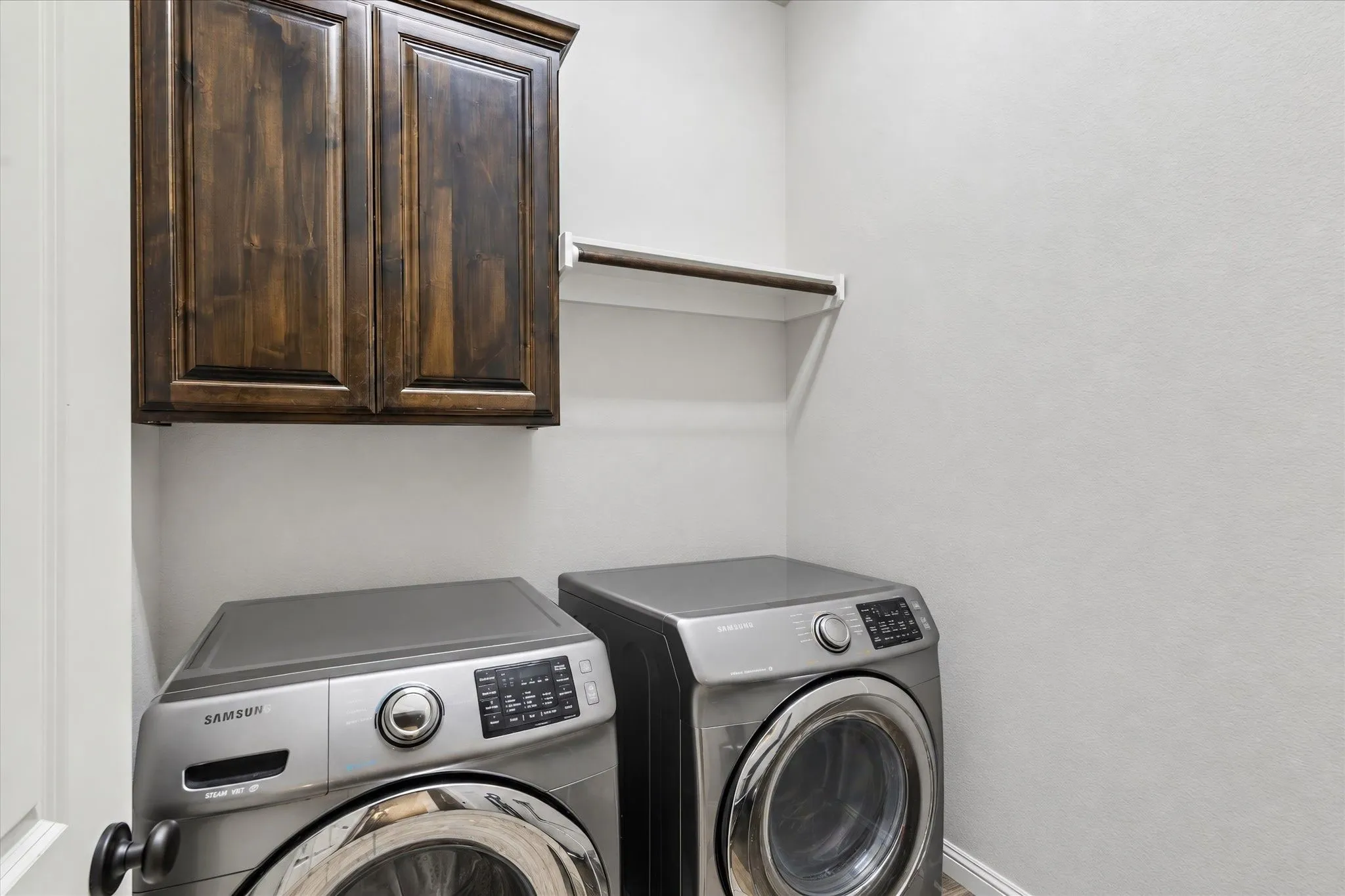 Built-in wood-finish cabinetry and an integrated shelf provide utility