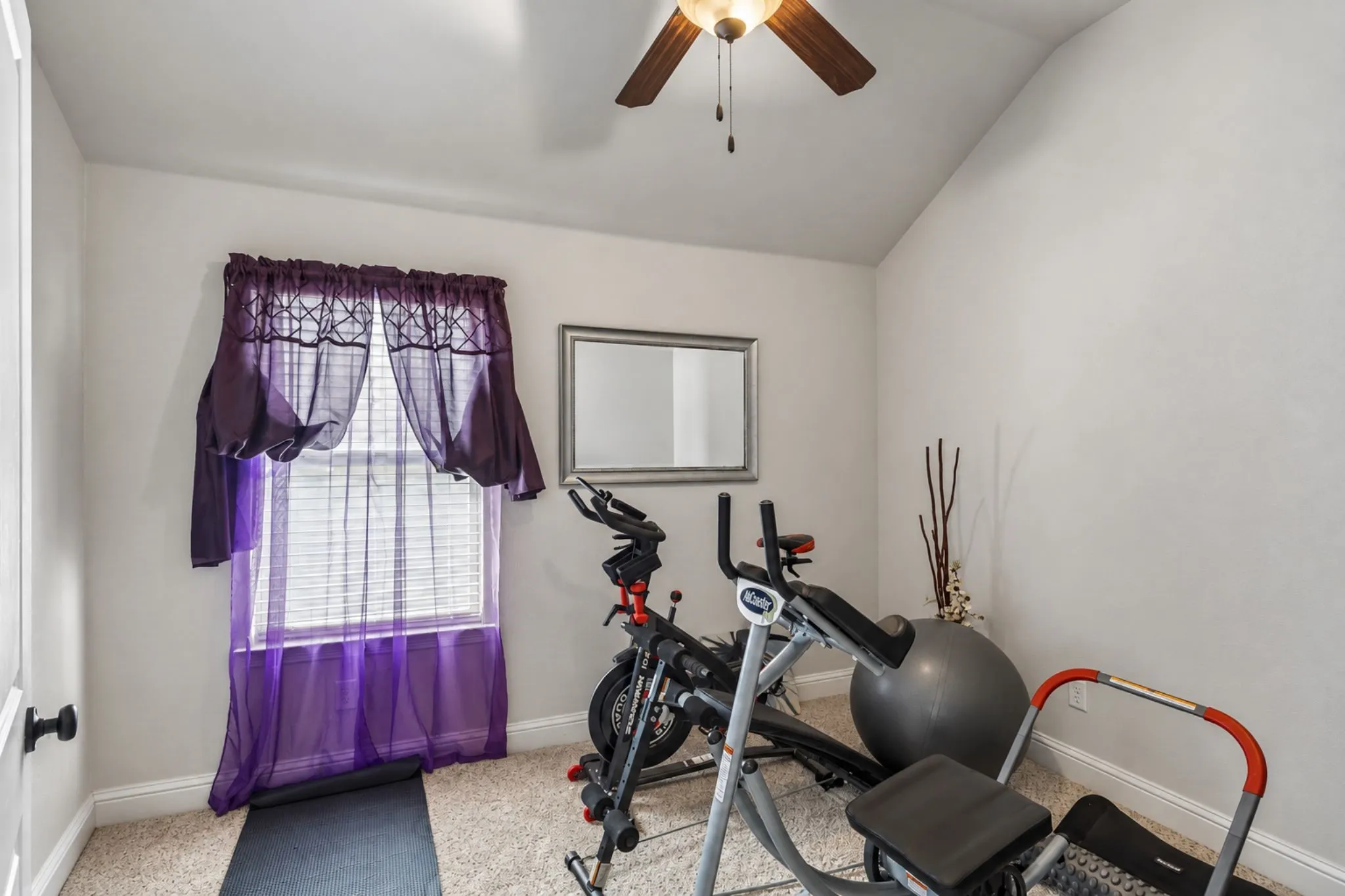 Vaulted ceiling with a ceiling fan, carpeted flooring, and window with blinds