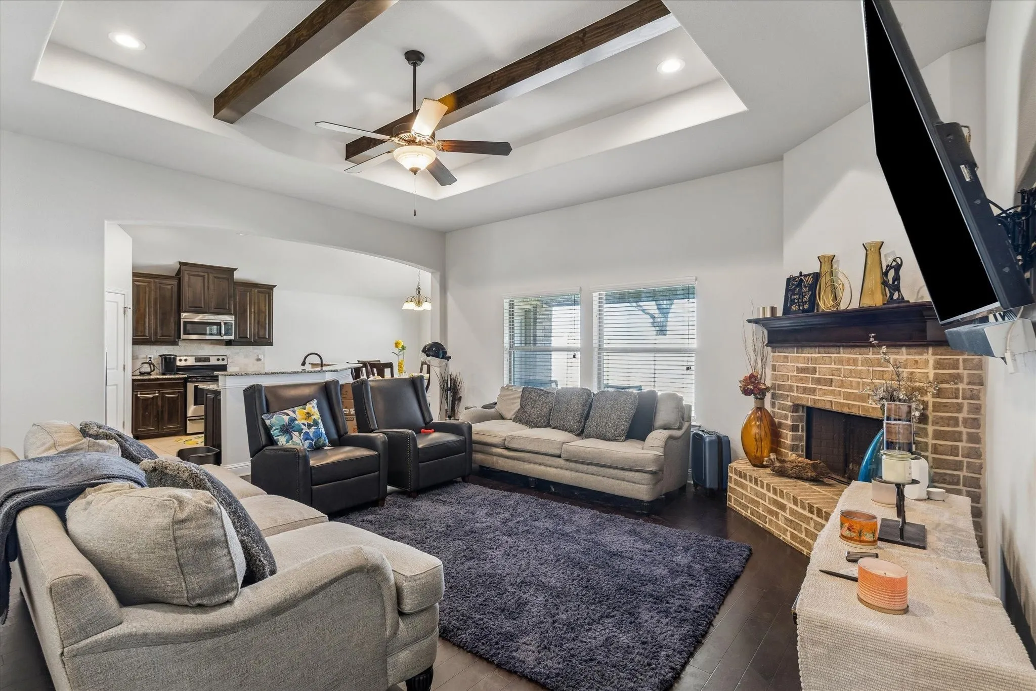 Vaulted ceiling with wood beams and recessed lighting