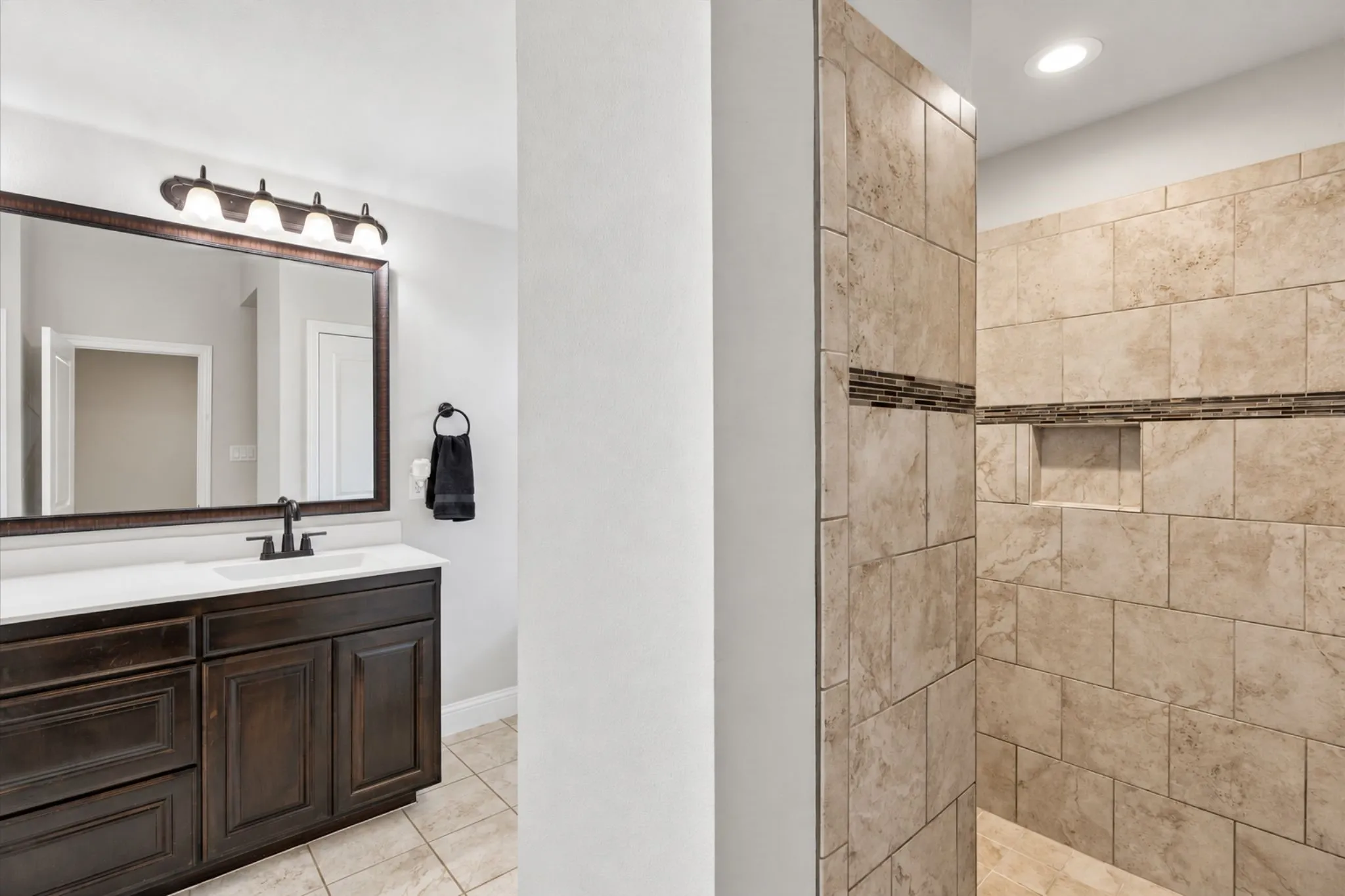 Dark wood-finish vanity with a white countertop and rectangular sink