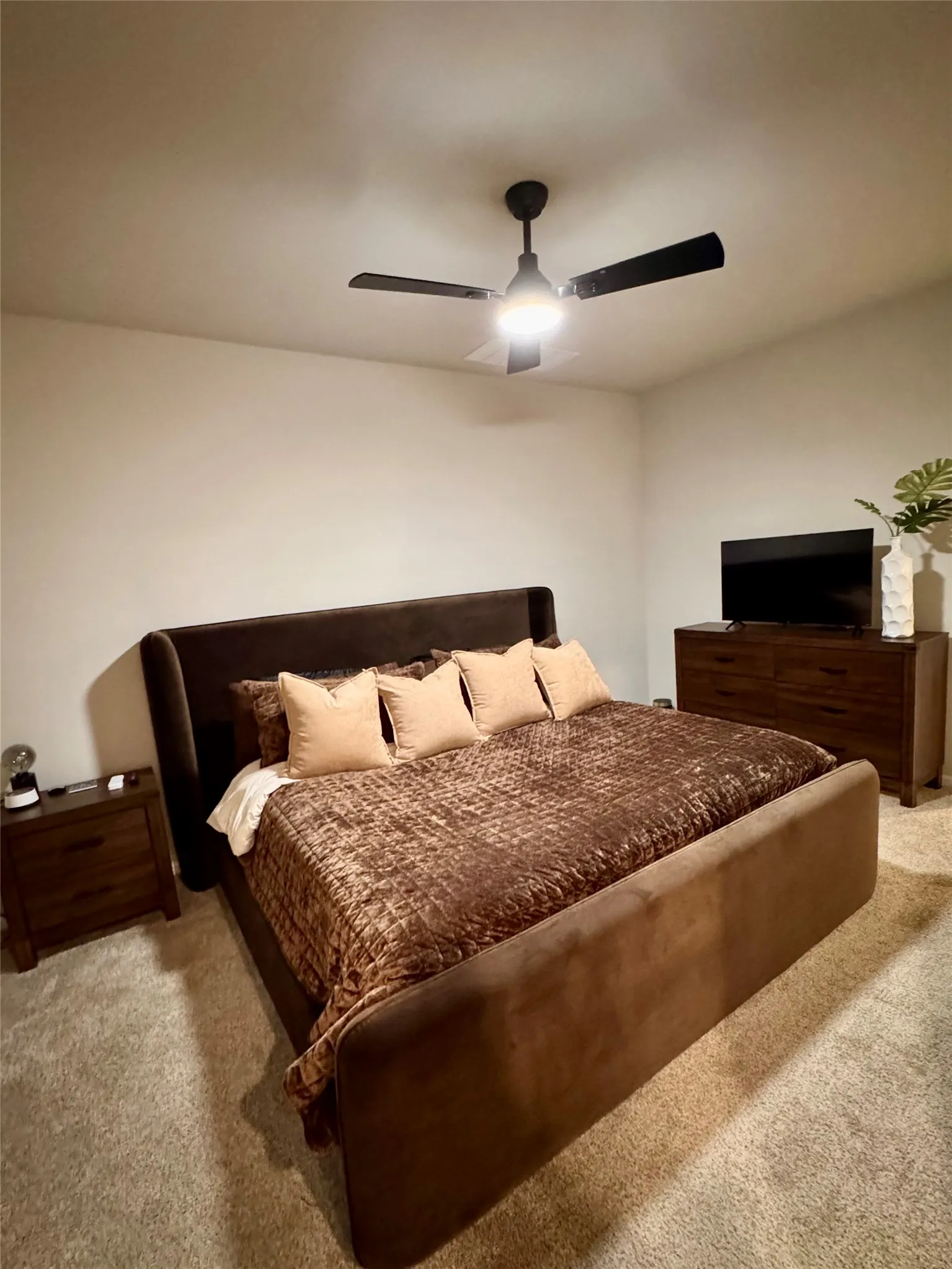 Primary bedroom with dresser and nightstand