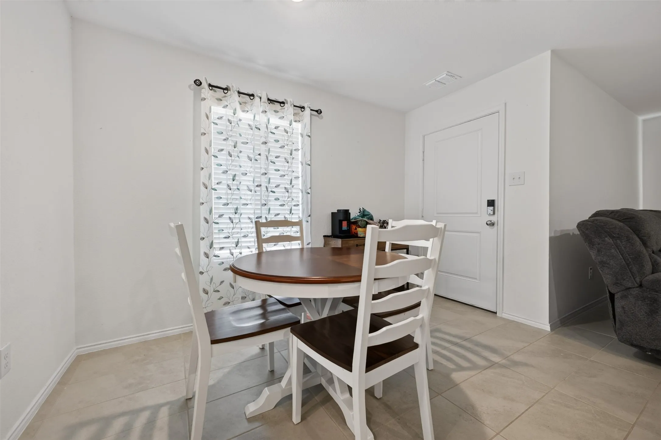 Tile flooring, white walls, white trim, recessed lighting, white panel door