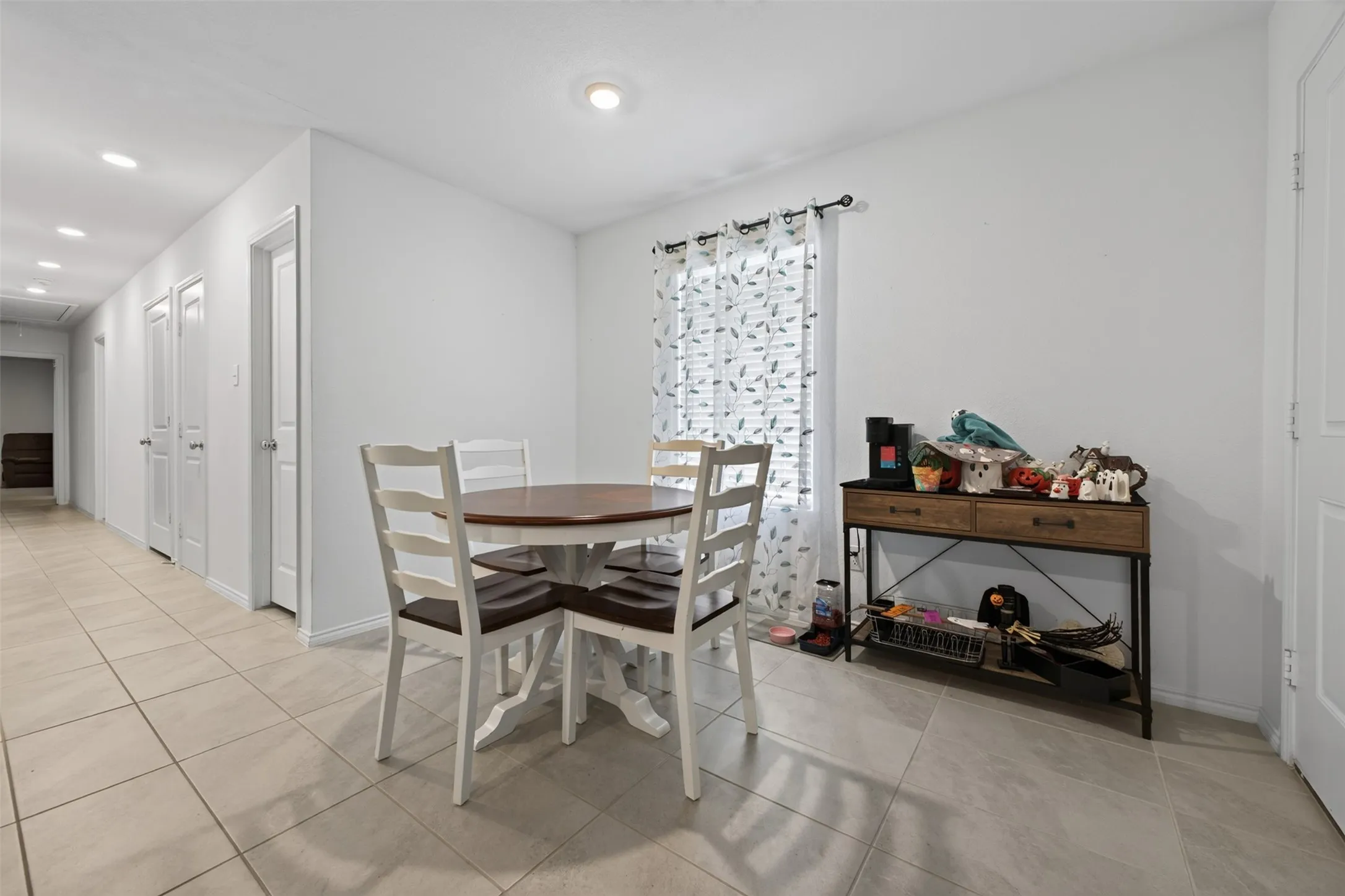 Recessed lighting, light-toned tile flooring, and white interior doors