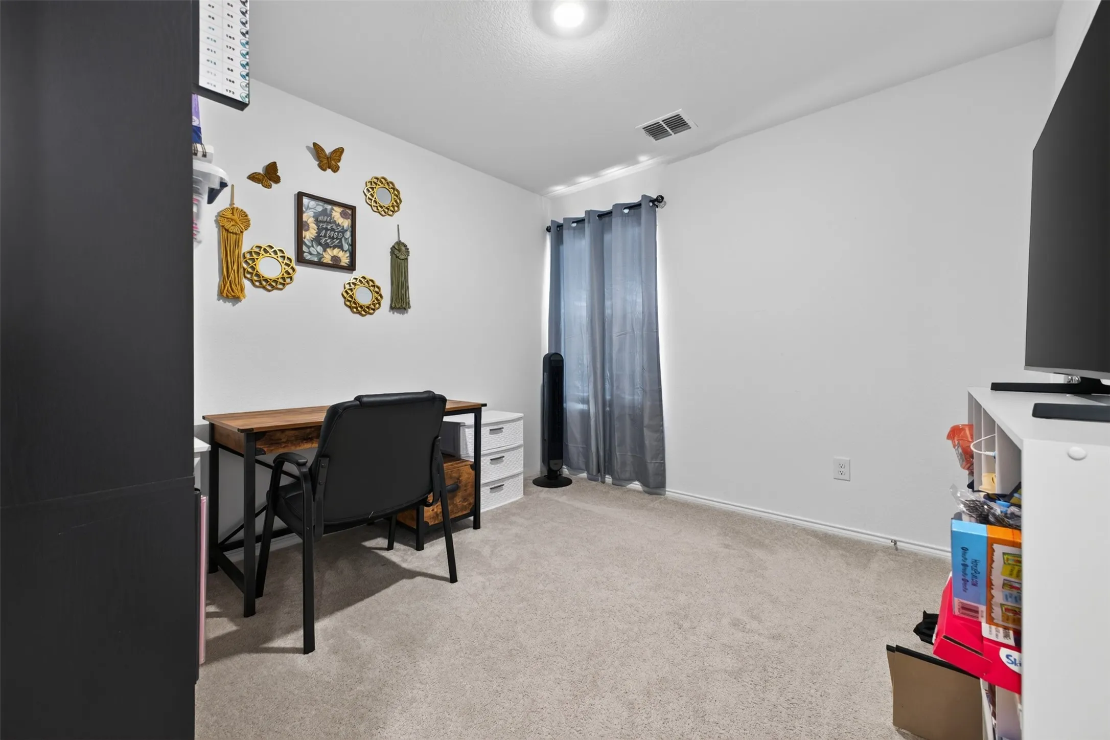 Carpeted flooring, recessed lighting, and a window with curtain rod