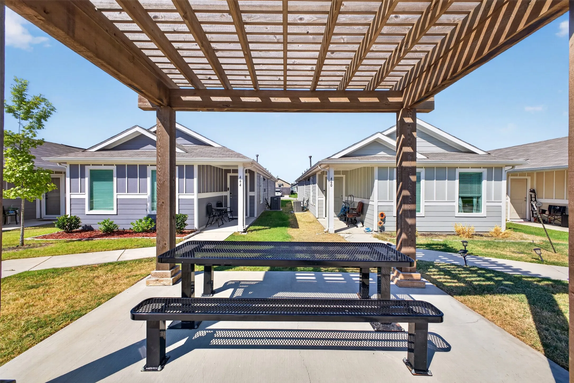 Wood pergola structure with concrete patio