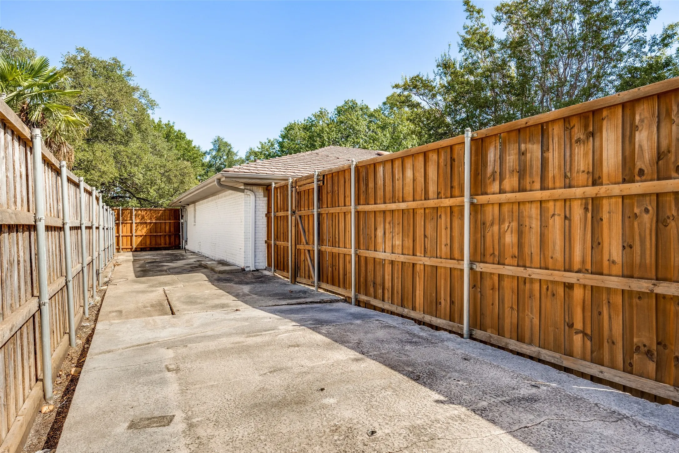 Gated side yard on other side of garage perfect for a shed and storage