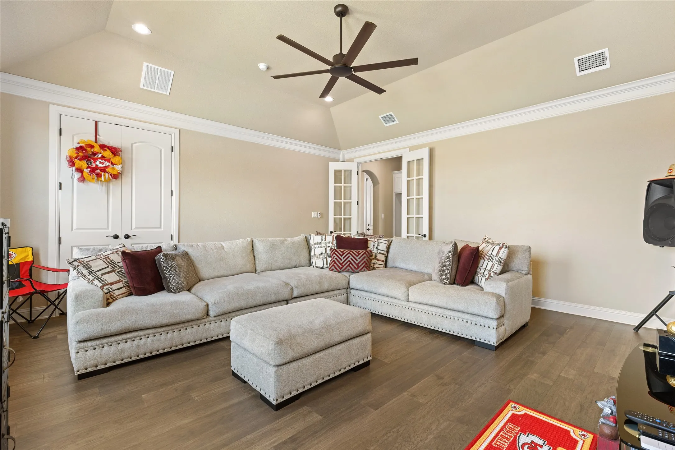 Vaulted ceiling with a ceiling fan and recessed lighting