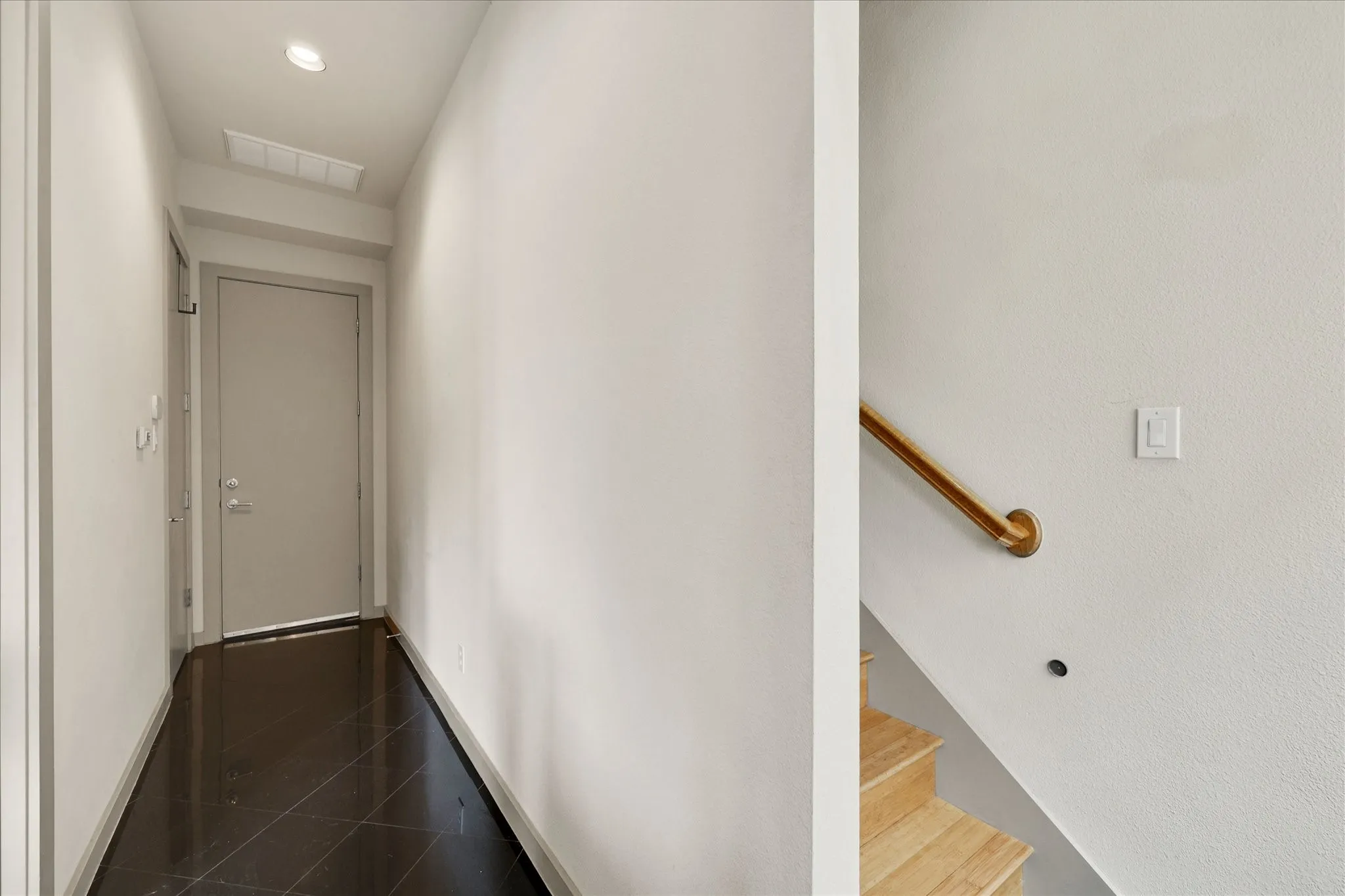 First bedroom is located on this first floor by the entry door. There is also stackable washer and dryer connections in this hallway