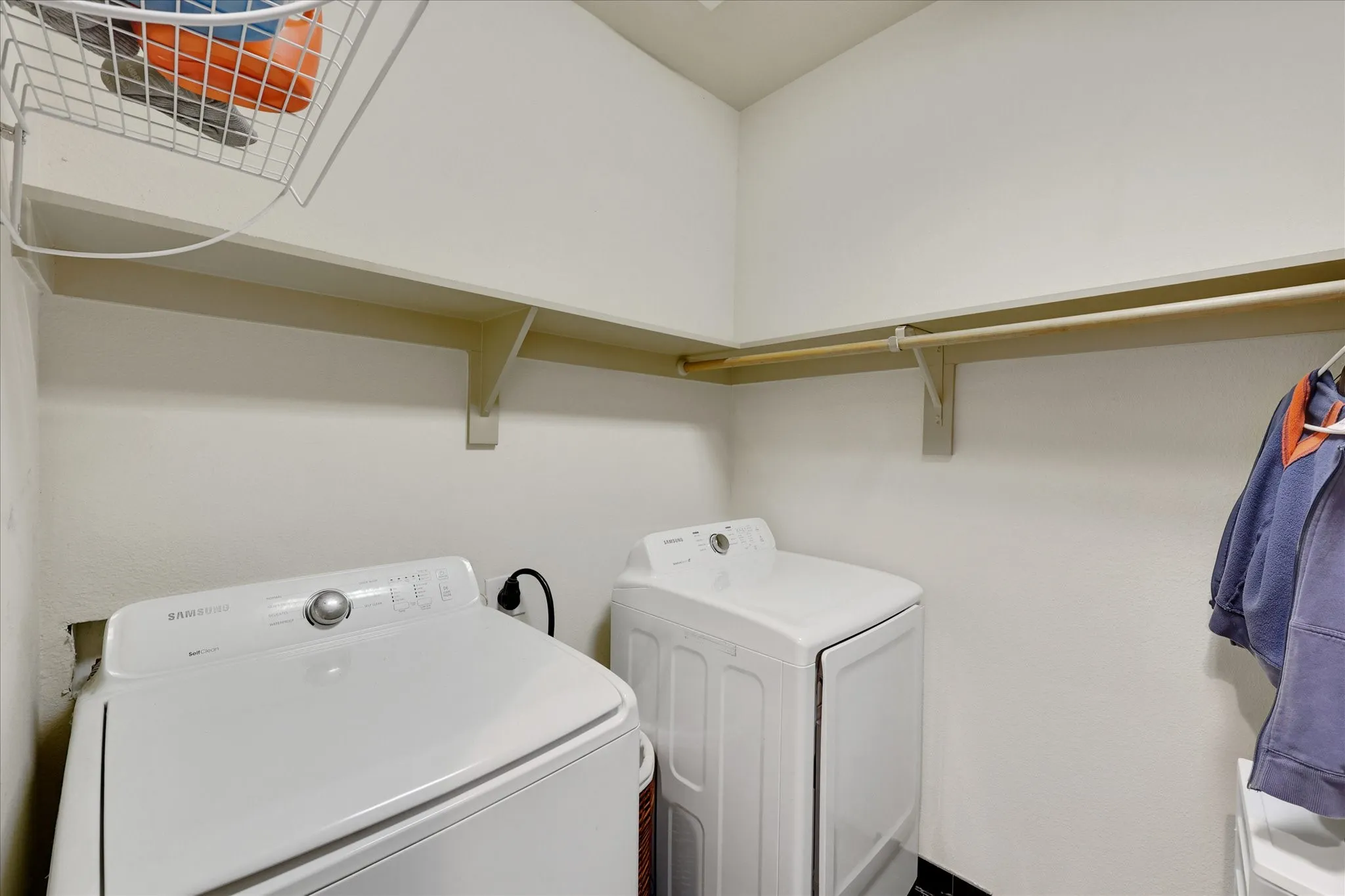 Full size washer and dryer space located in primary closet
