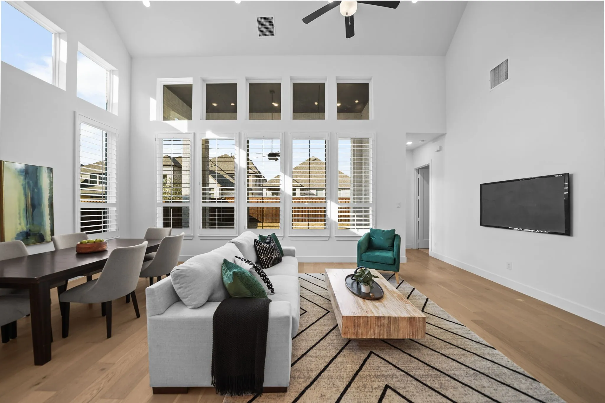 Vaulted ceilings, abundant natural light, wood-finish flooring, recessed lighting, and a ceiling fan
