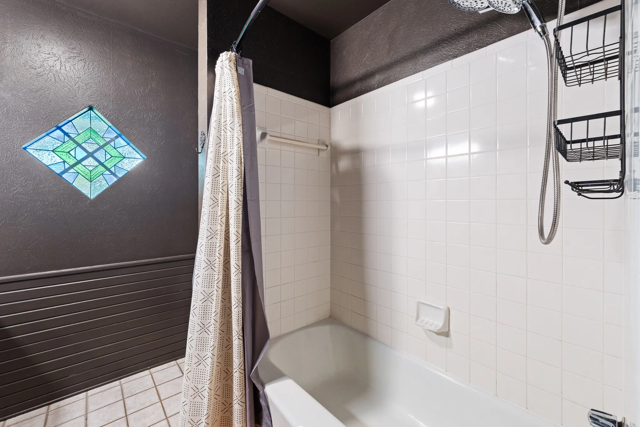 Tub and shower combination with white tile surround