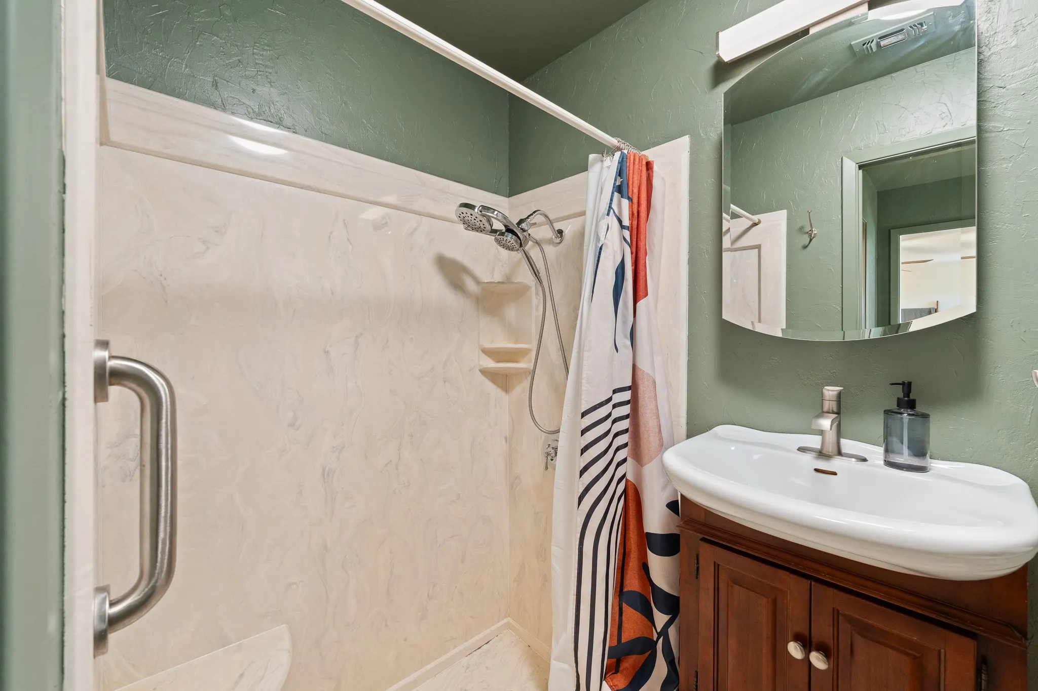 Shower with built-in shelving, showerhead, and grab bar