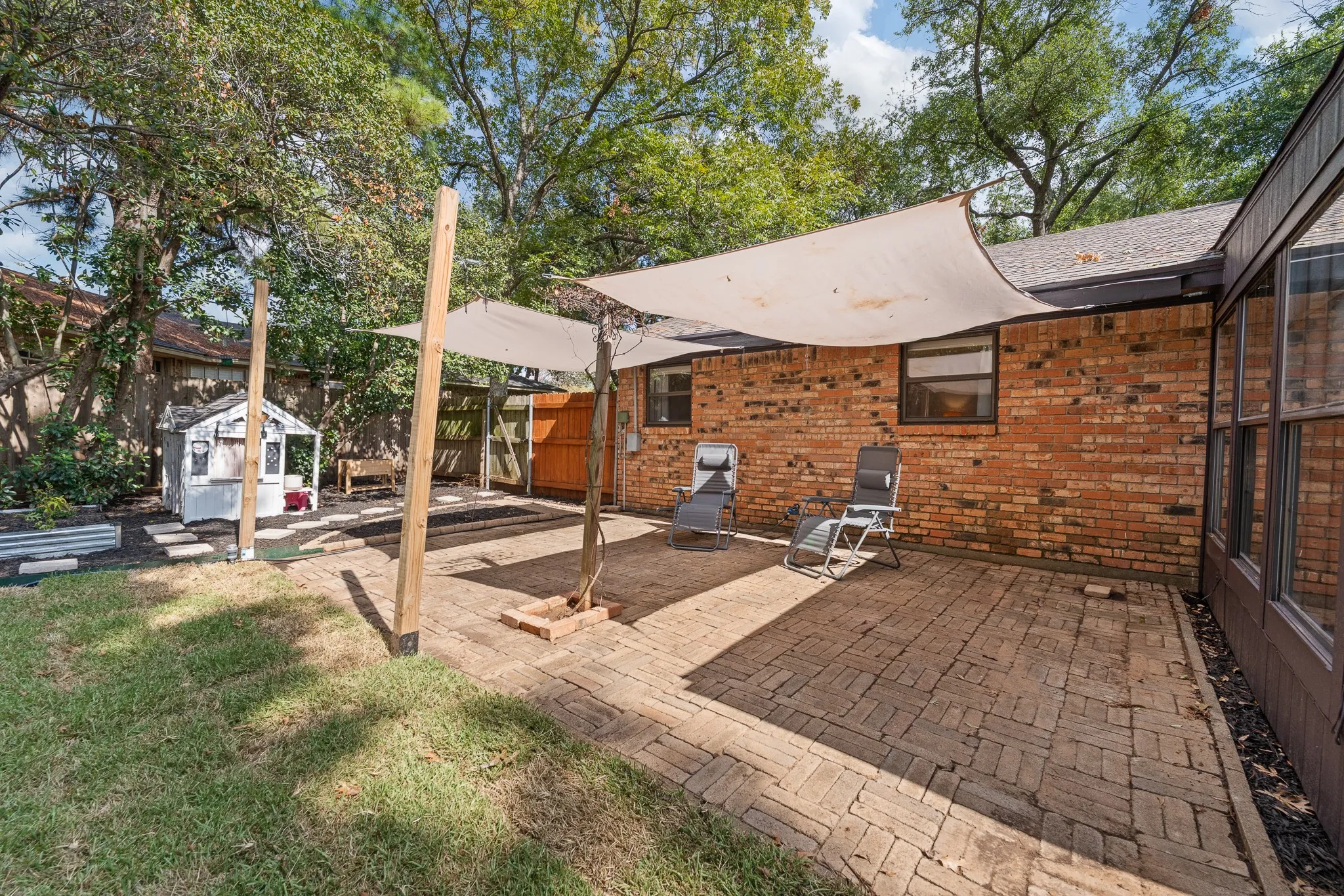 Brick paver patio with shade sails