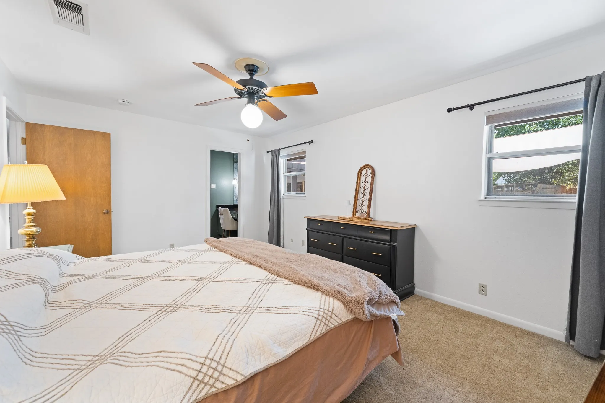Recessed lighting, ceiling fan, and light-colored carpeting