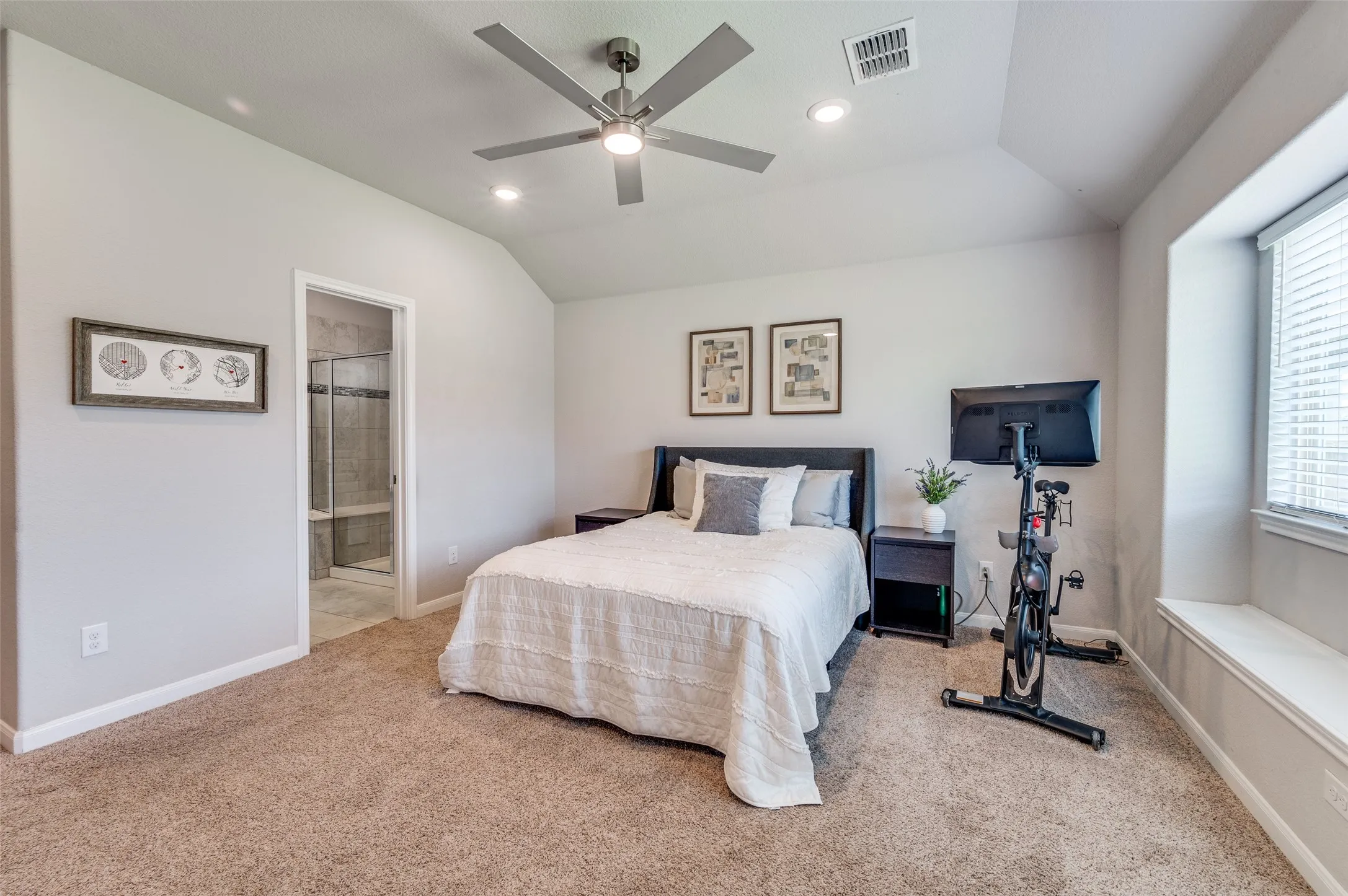 Vaulted ceiling with recessed lighting, ceiling fan, and carpeted flooring