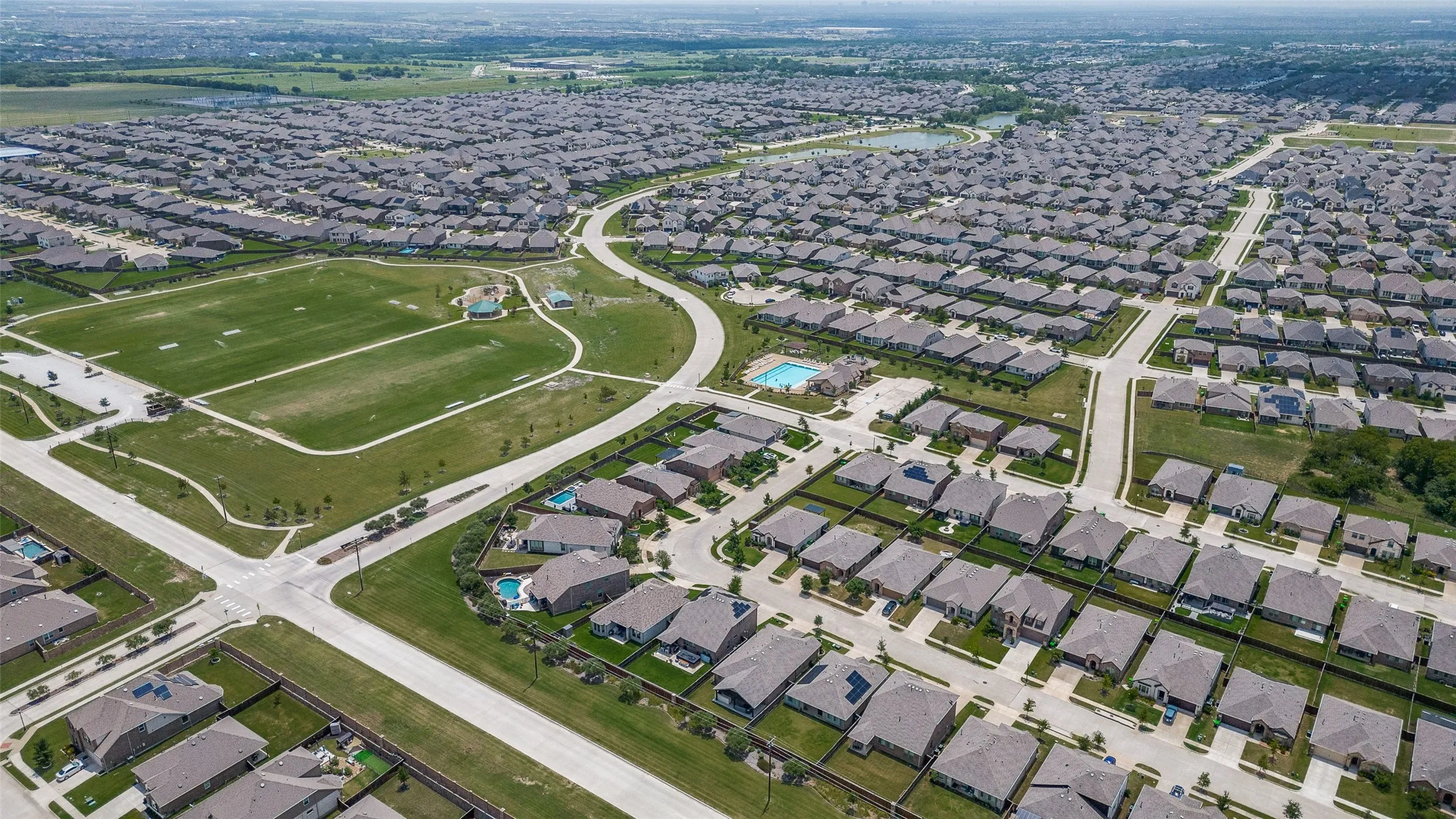 Residential community featuring uniform-style homes and an integrated recreational green space