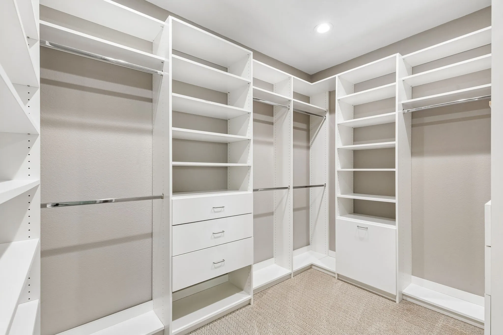 The primary suite’s custom Closets by Design system offers extensive hanging space, shelving and built-in drawer storage.