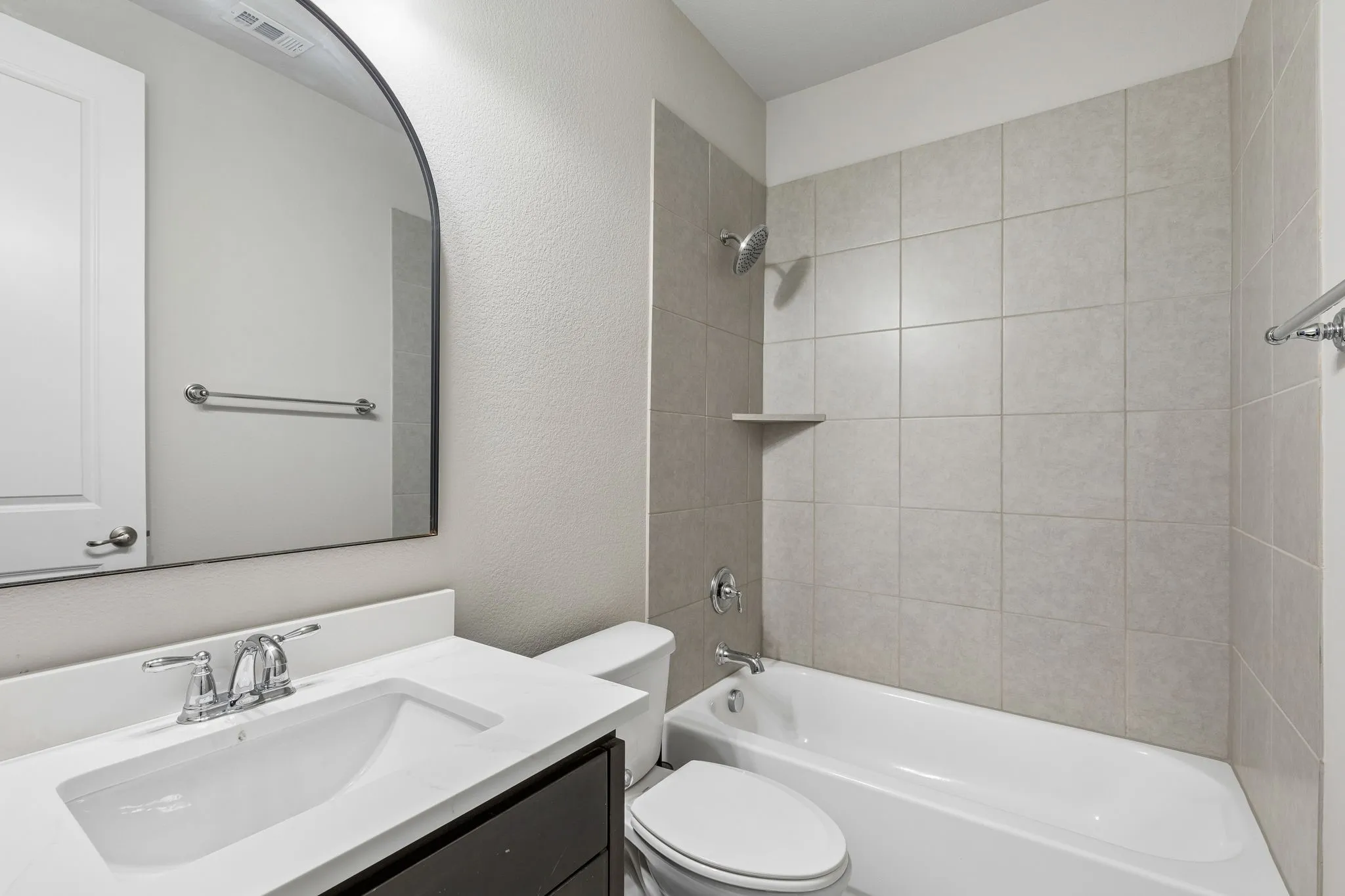 The first-floor guest bath is refreshed with a new 2026 quartz countertop and offers a full tub/shower combination.