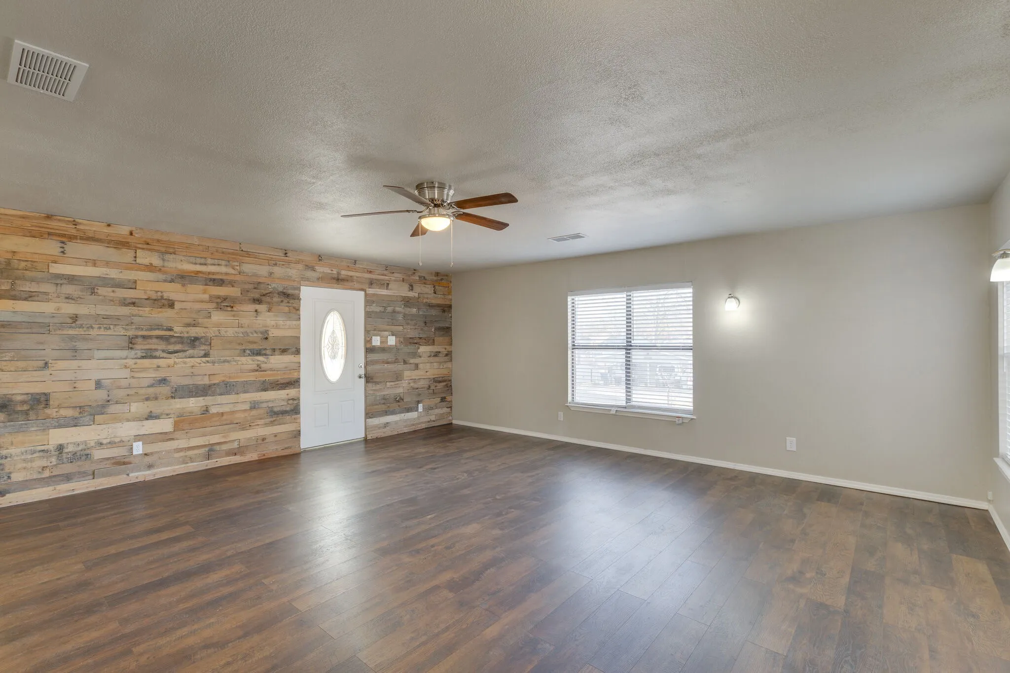 Livingroom featuring an accent wall - NO virtual staging