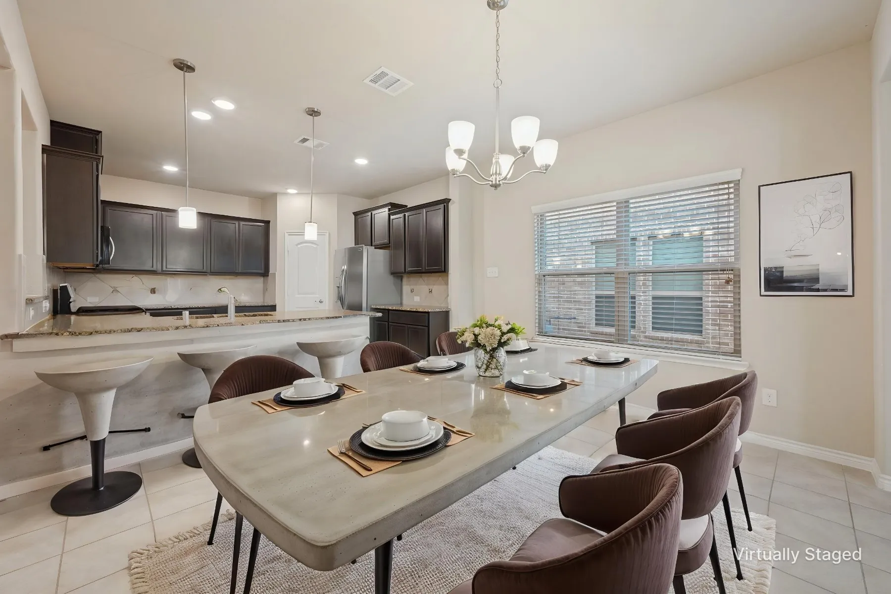 Kitchen and dining area featuring dark wood-finish cabinetry, a breakfast bar, recessed lighting, and tile flooring