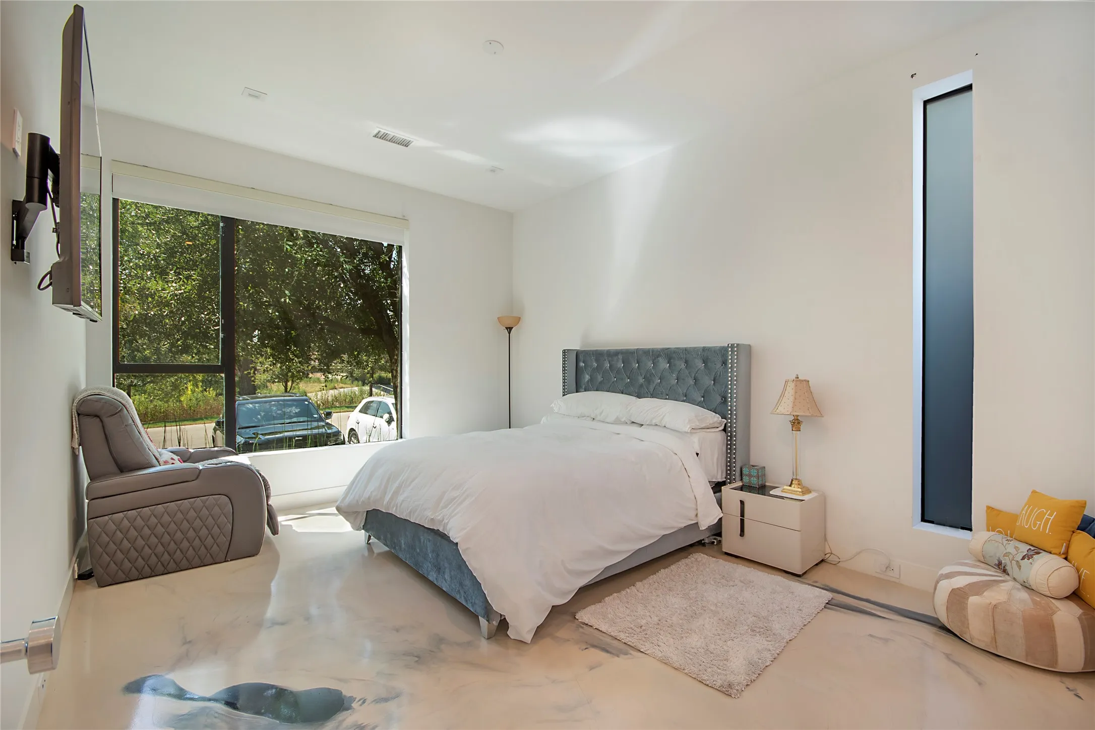 White walls with a large picture window, a tall narrow window, and high-gloss flooring