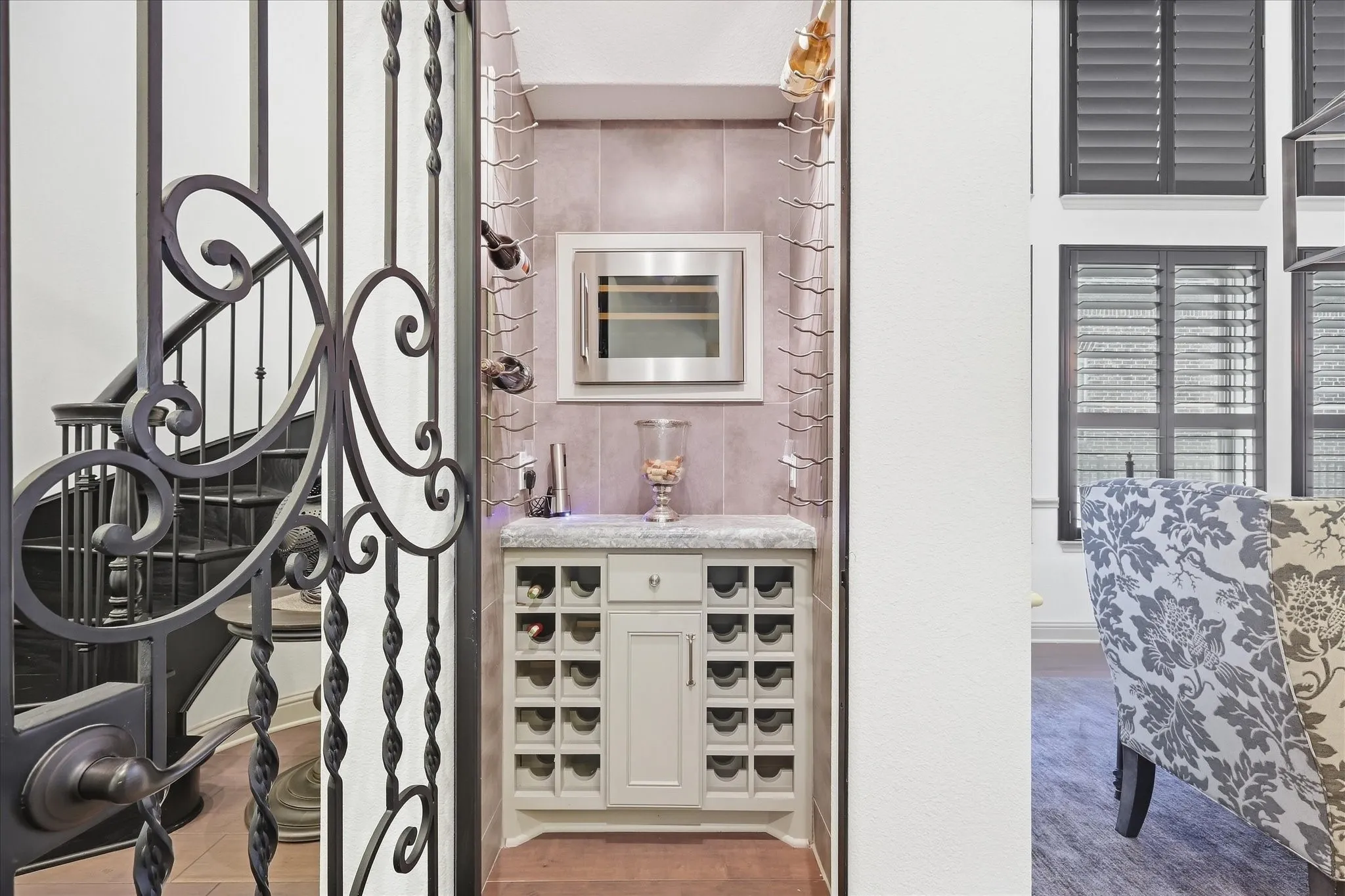 Wine room with wrought iron gate