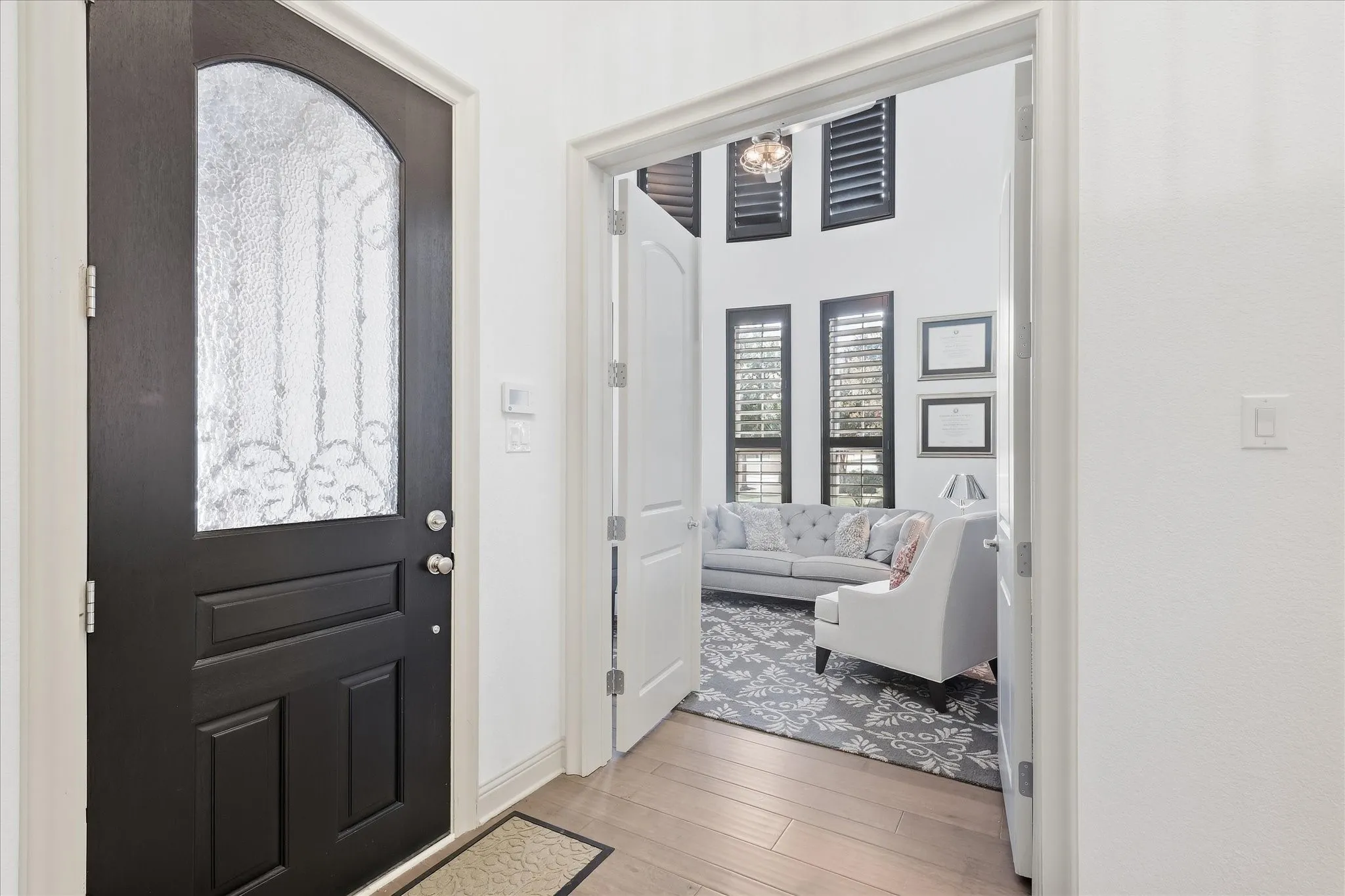Arched glass panel front door with wrought iron detailing