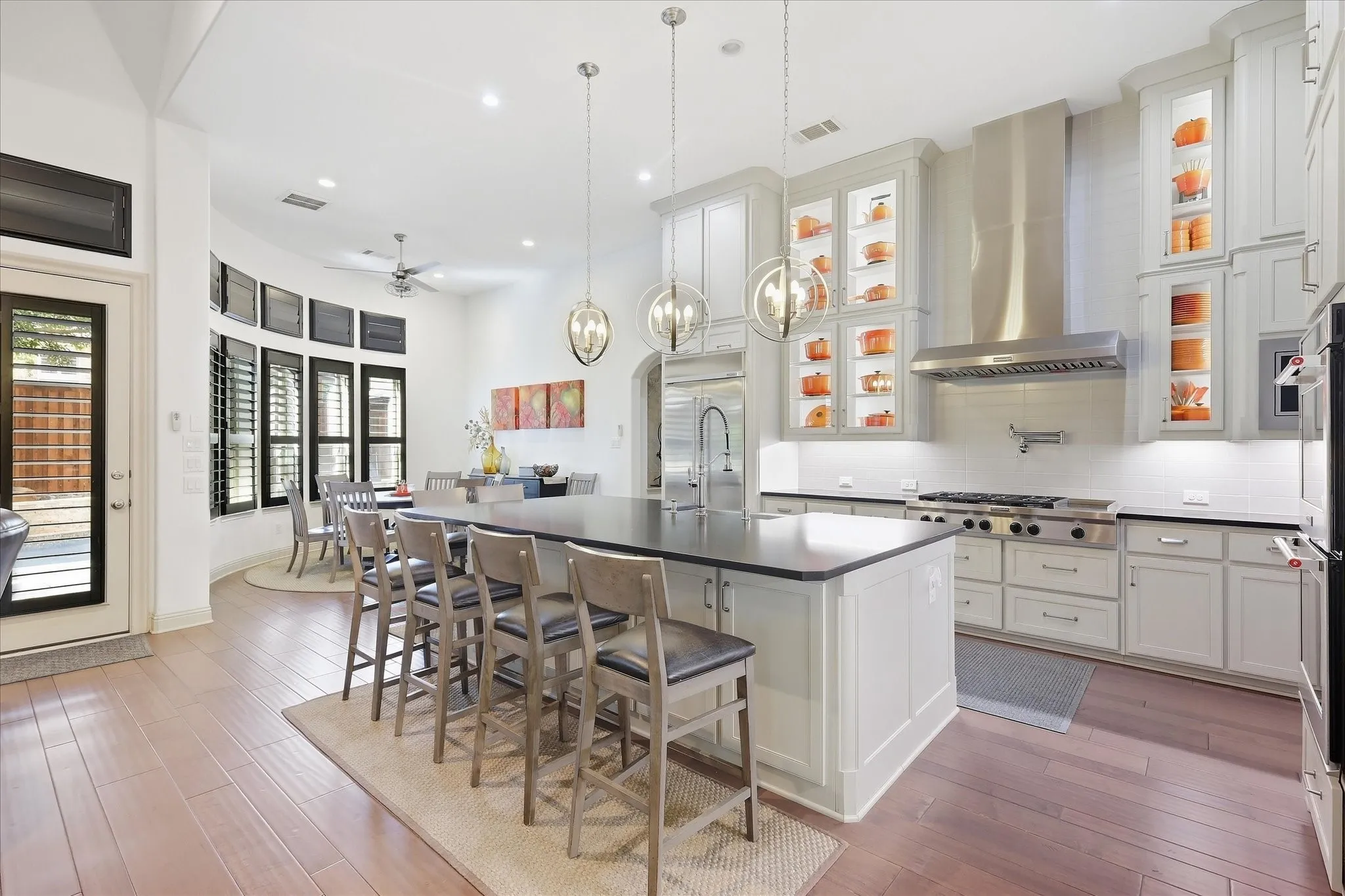 Gourmet kitchen with a large island, stainless steel appliances, and white cabinetry
