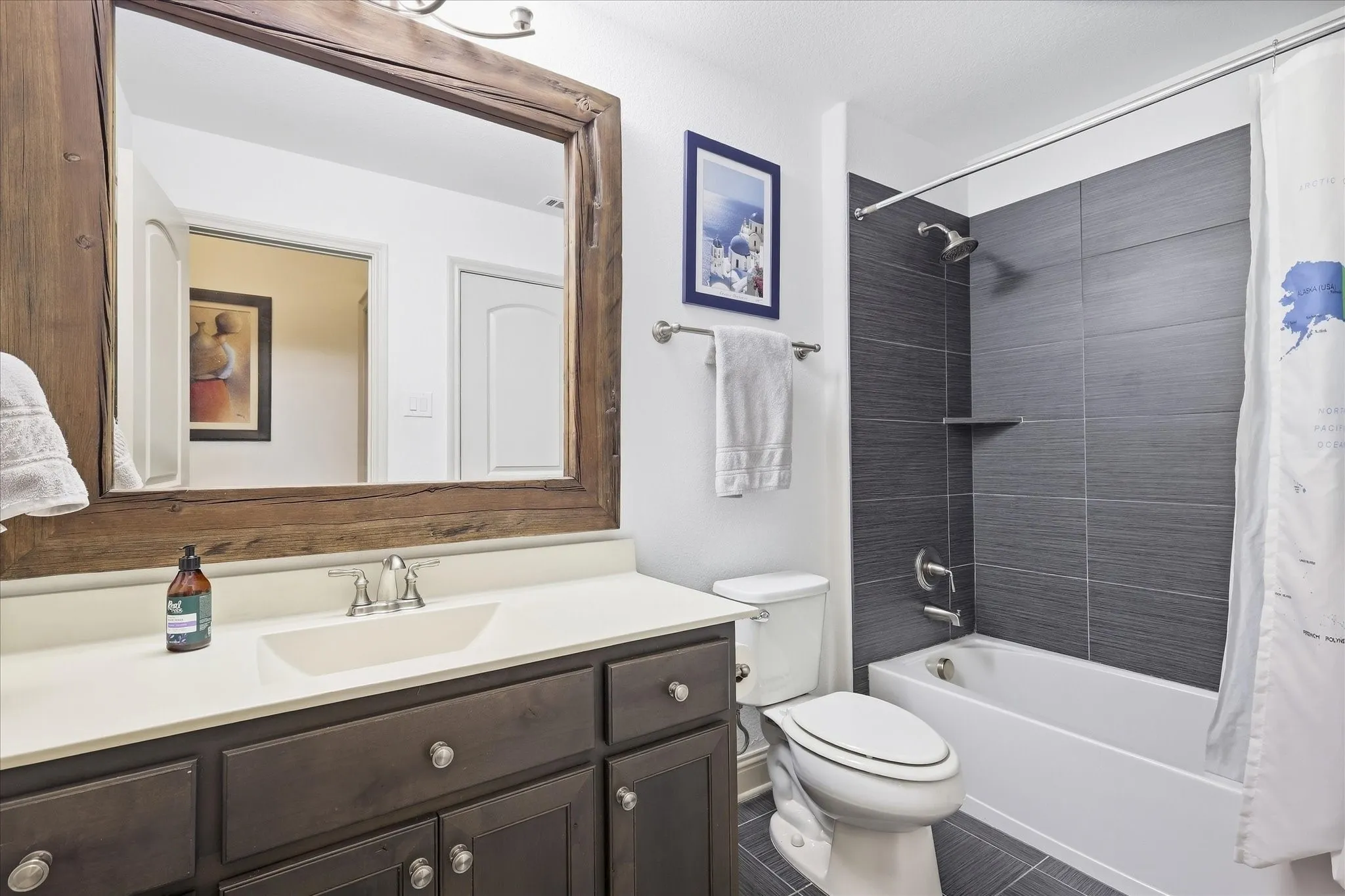 Dark wood-finish vanity with a light-toned countertop and an undermount sink