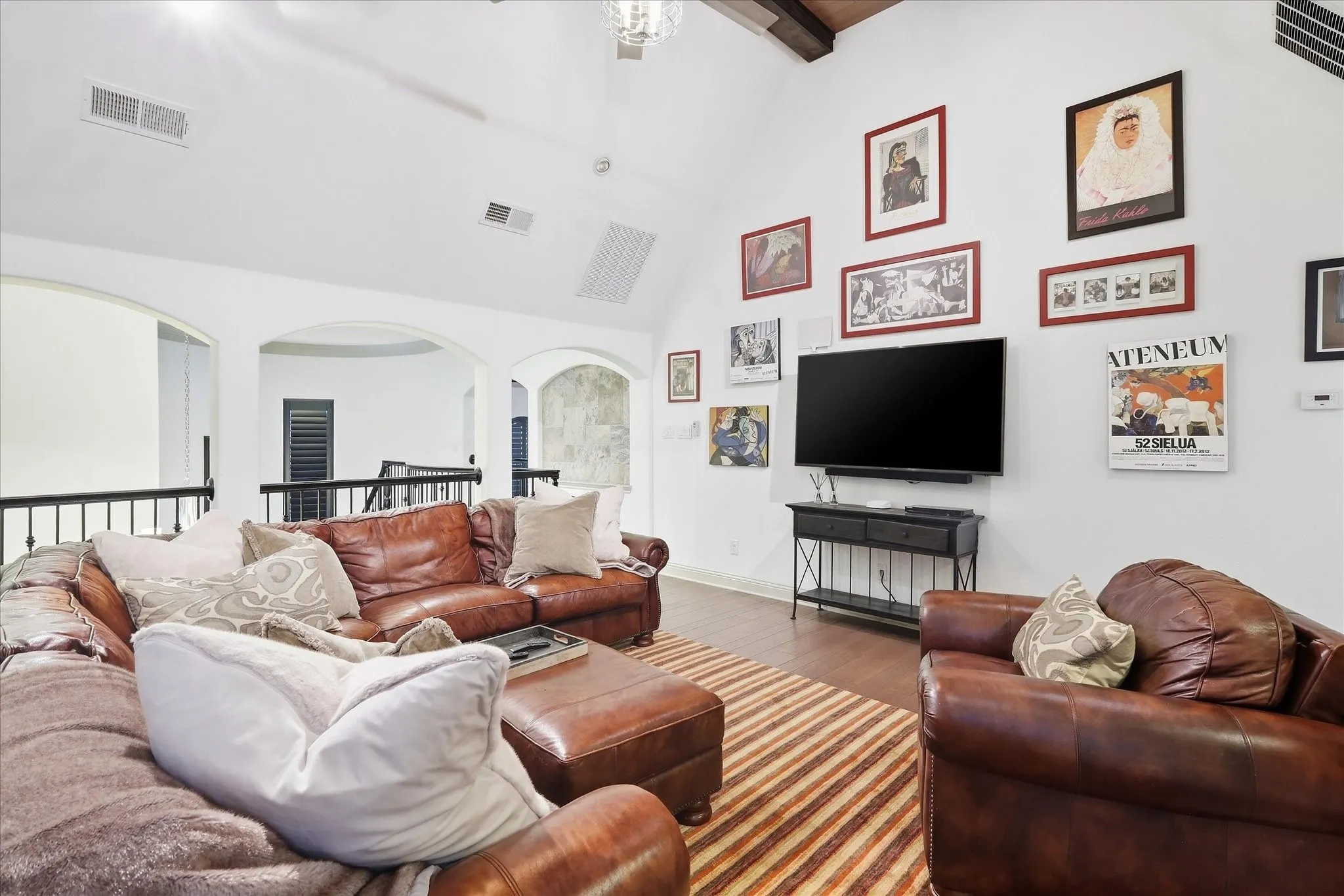 Vaulted ceiling featuring exposed wood beams