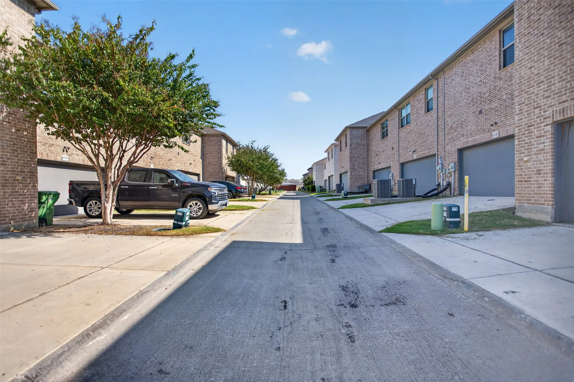Brick exterior with individual garage access and concrete driveways
