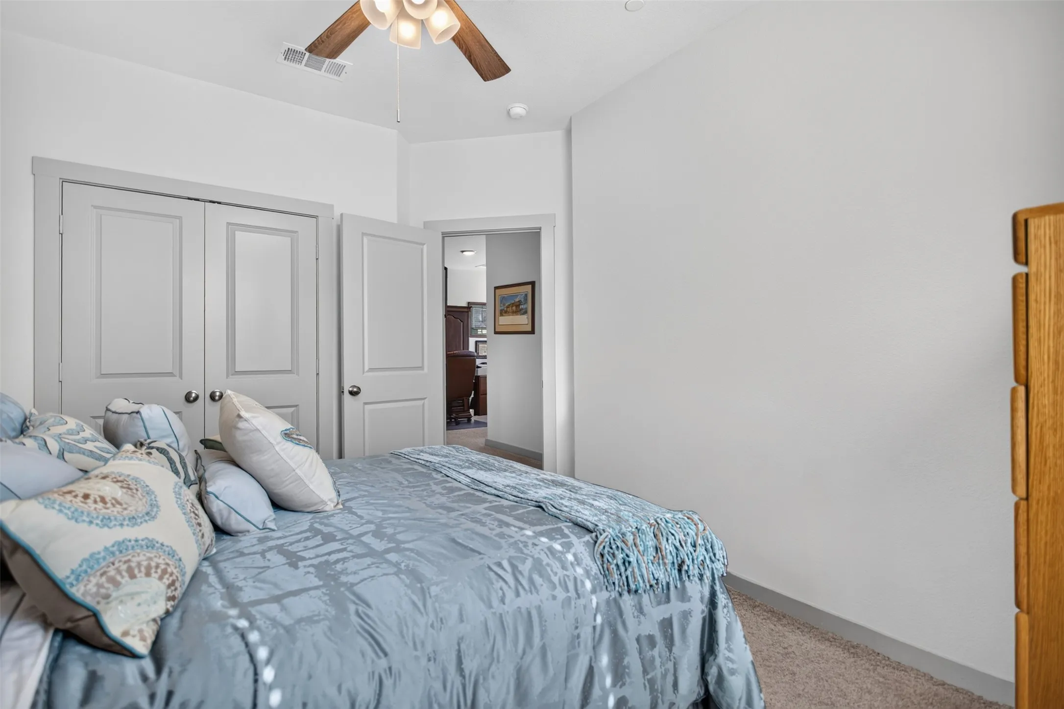 Bedroom featuring a ceiling fan, light-colored walls, carpeted flooring, and white panel doors