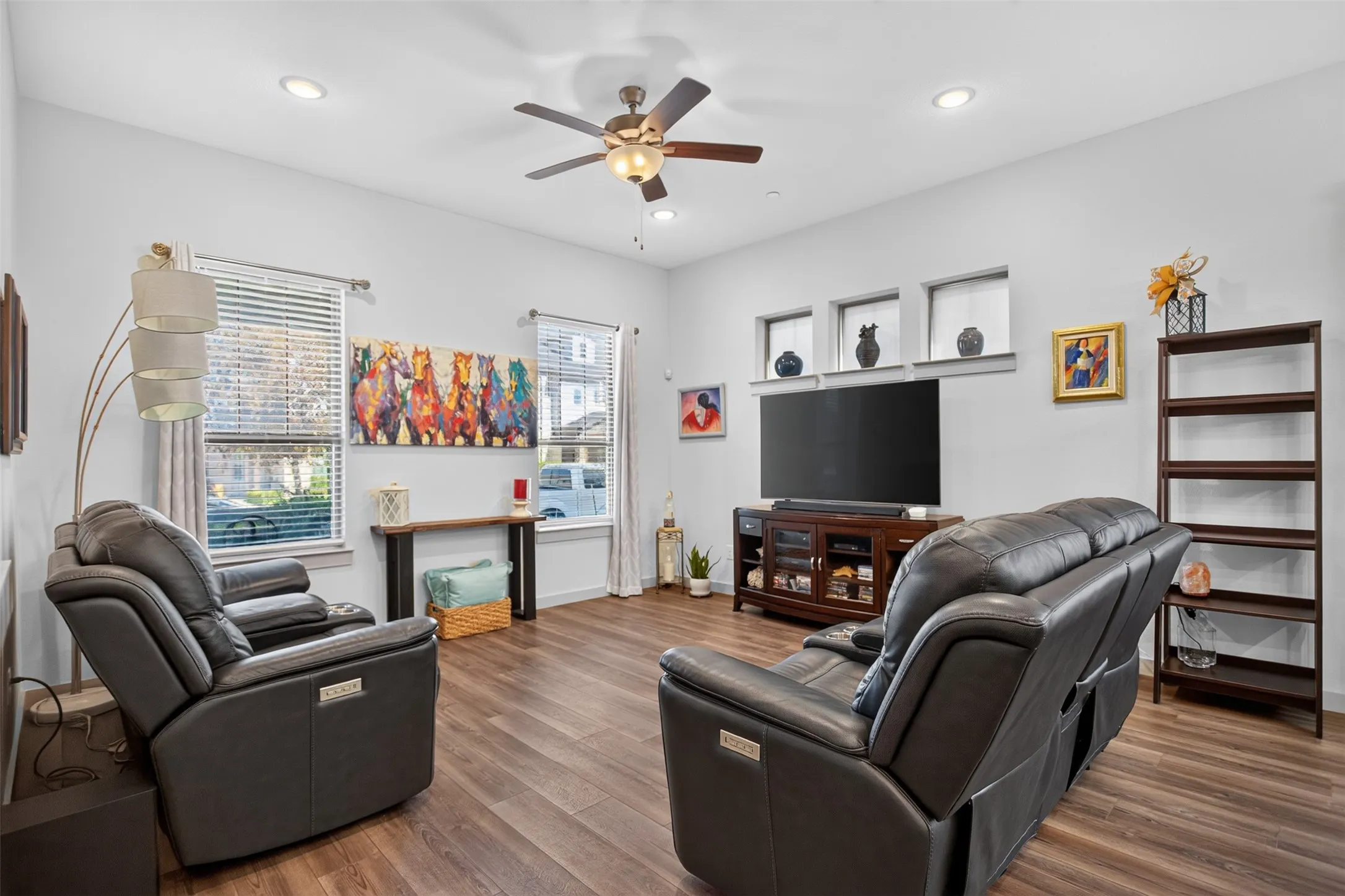 Wood-finish flooring throughout, recessed lighting, and a ceiling fan with integrated light fixture