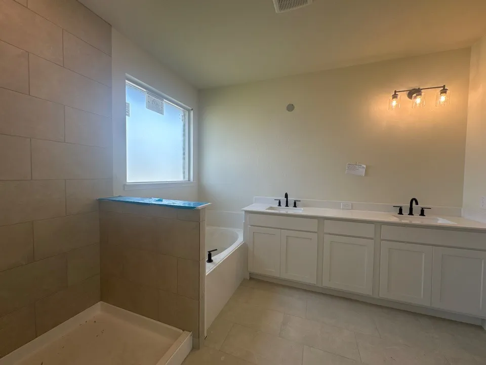Dual vanity with white cabinetry and integrated sinks
