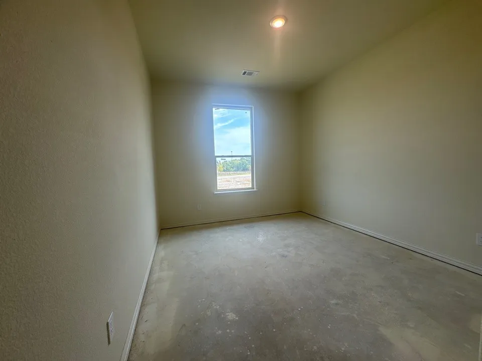 Recessed ceiling light fixture, framed window, smooth ceiling finish, textured wall finish, clean white trim
