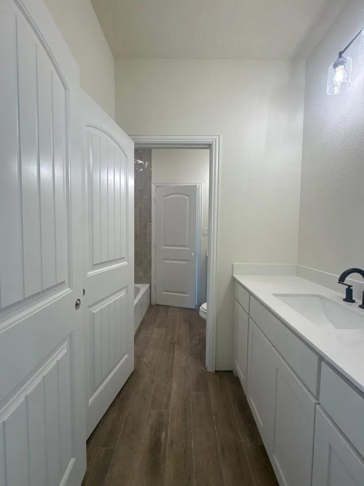 Wood-finish flooring extending through the space