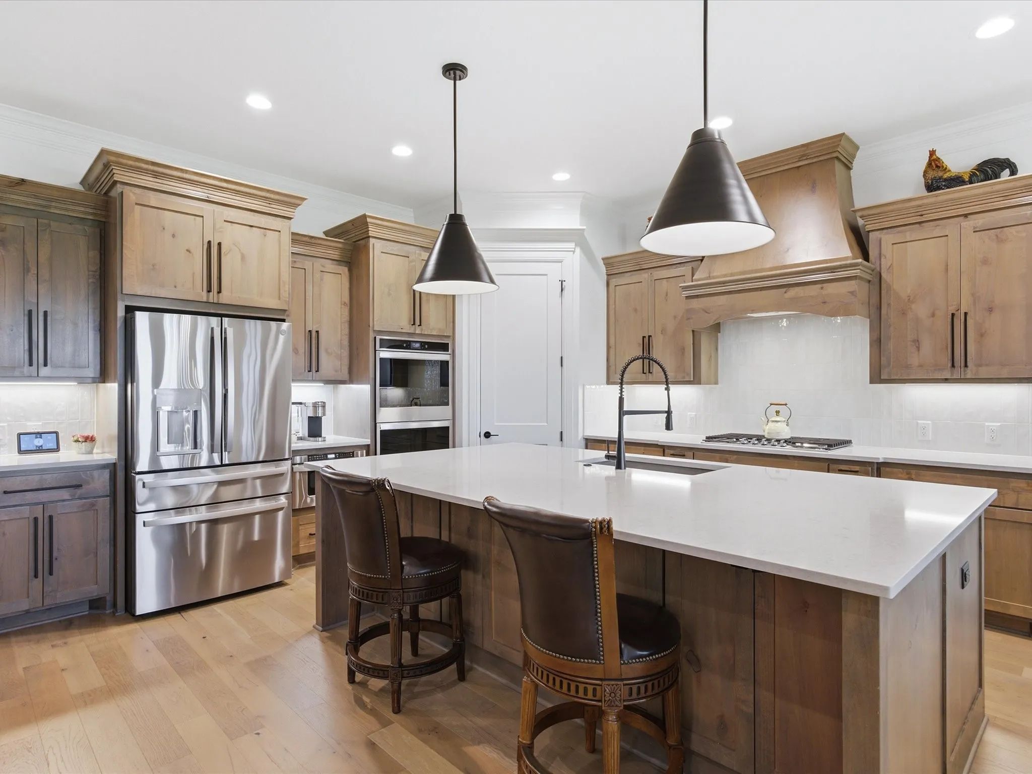 Beautiful quartz counter-tops and wood cabinets highlight the gourmet kitchen.
