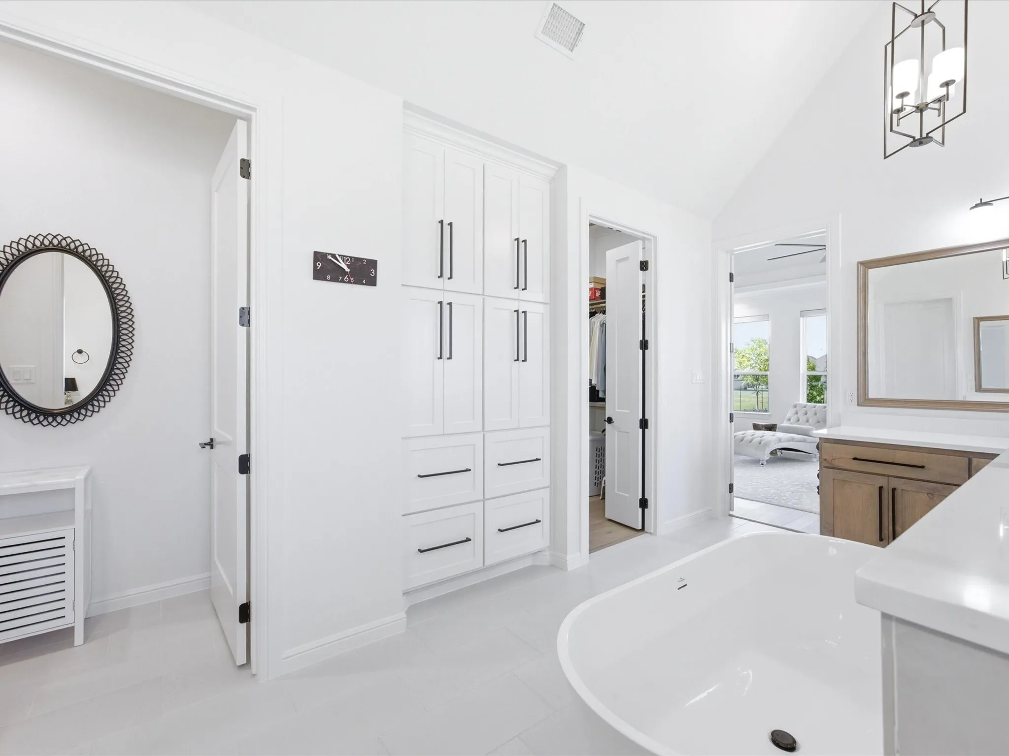 Separate vanities and a wall of linen closet space provides an abundance of storage.