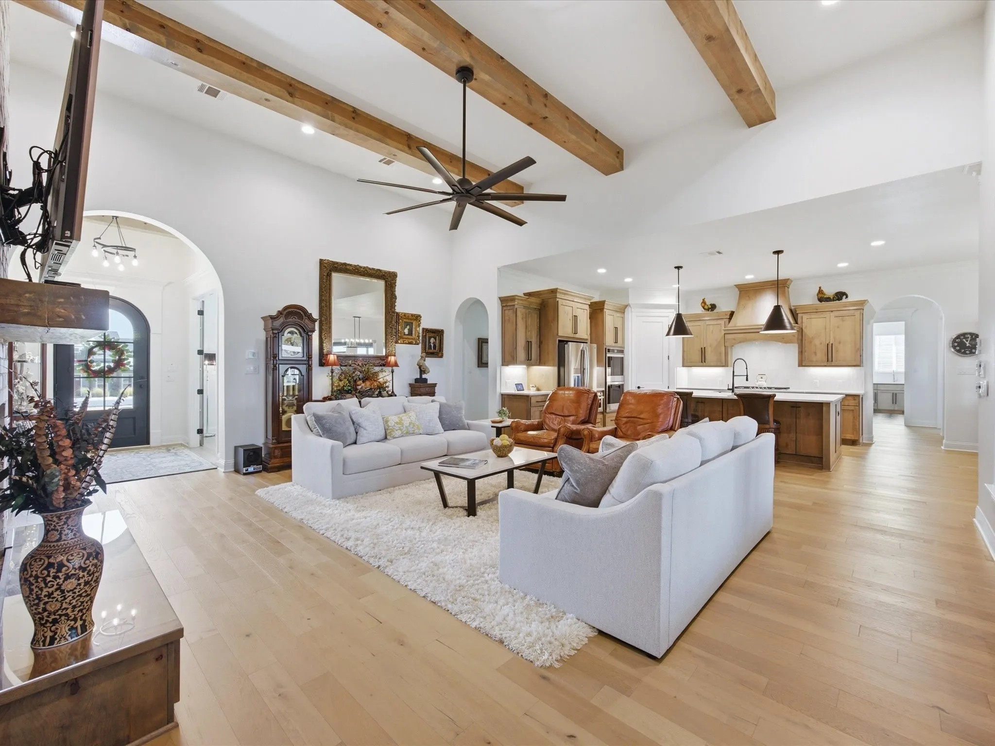 A spacious living room showcases rich wood beamed ceilings.
