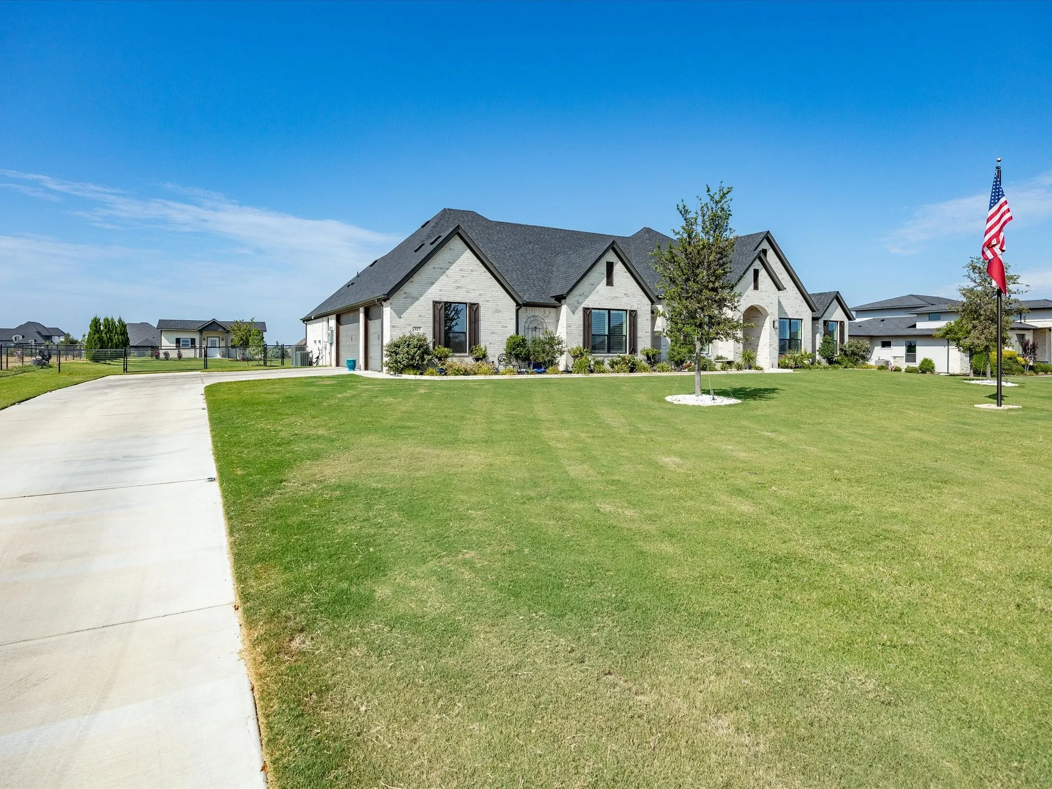 A three-car side entry garage and long drive-way offers ample parking.