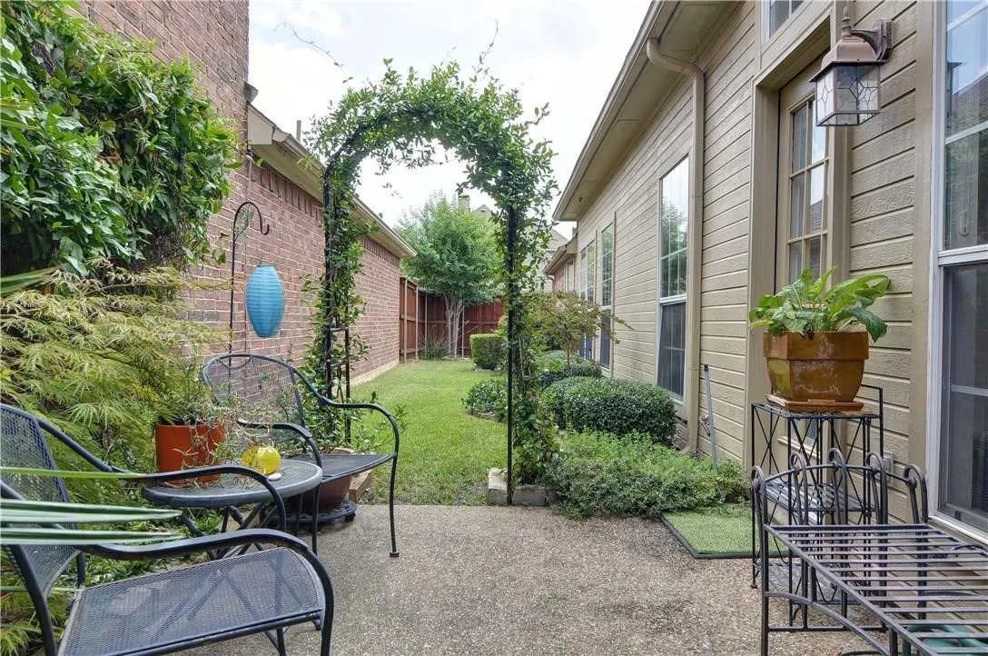 Concrete patio with a vine-covered archway