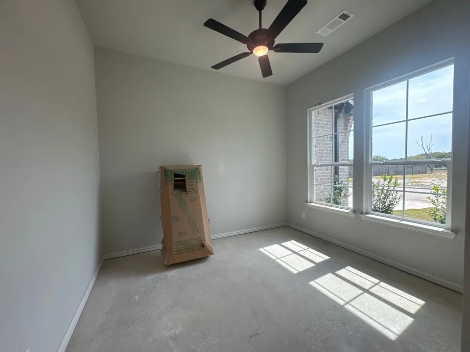 Vaulted ceiling with a flush-mount ceiling fan, and two large multi-pane windows