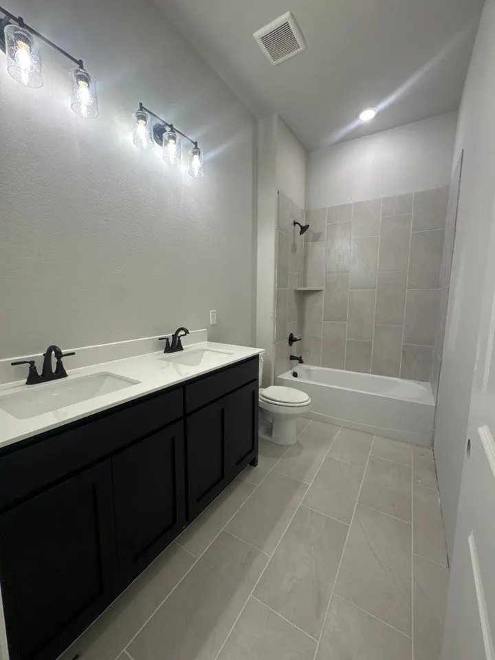 Dual vanity with white countertop and black cabinetry